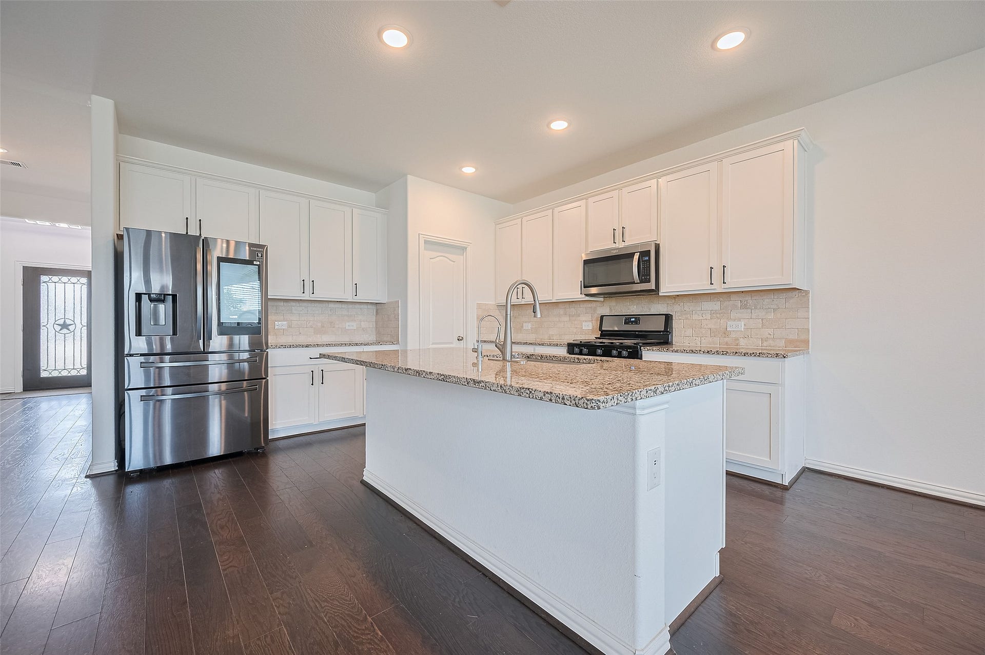 31326 Whitfield Court, Fulshear, TX 77441 Modern kitchen features a central island.