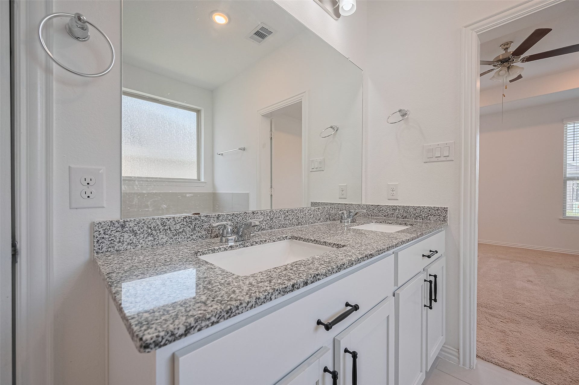 31326 Whitfield Court, Fulshear, TX 77441 A dual sink vanity with ample storage and a large mirror.