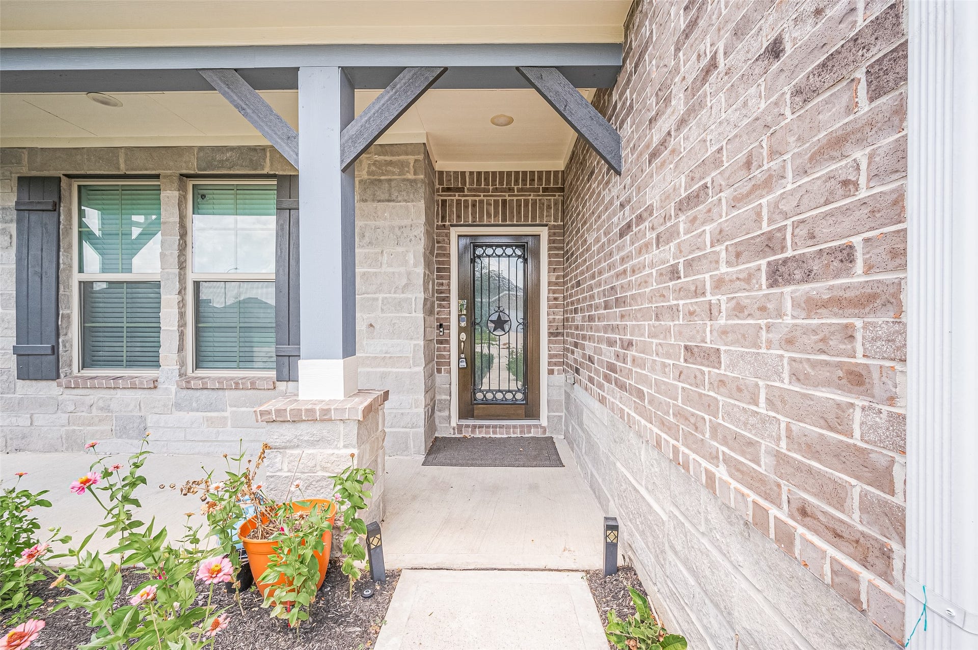 31326 Whitfield Court, Fulshear, TX 77441 Front entrance features a brick and stone faade and decorative door with glass panels.