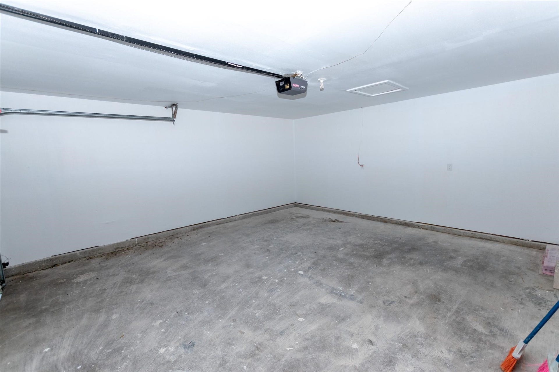 5610 Wallis Trail Court, Houston, TX 77049 Spacious garage with clean, unfinished concrete flooring and ample room for storage or parking.