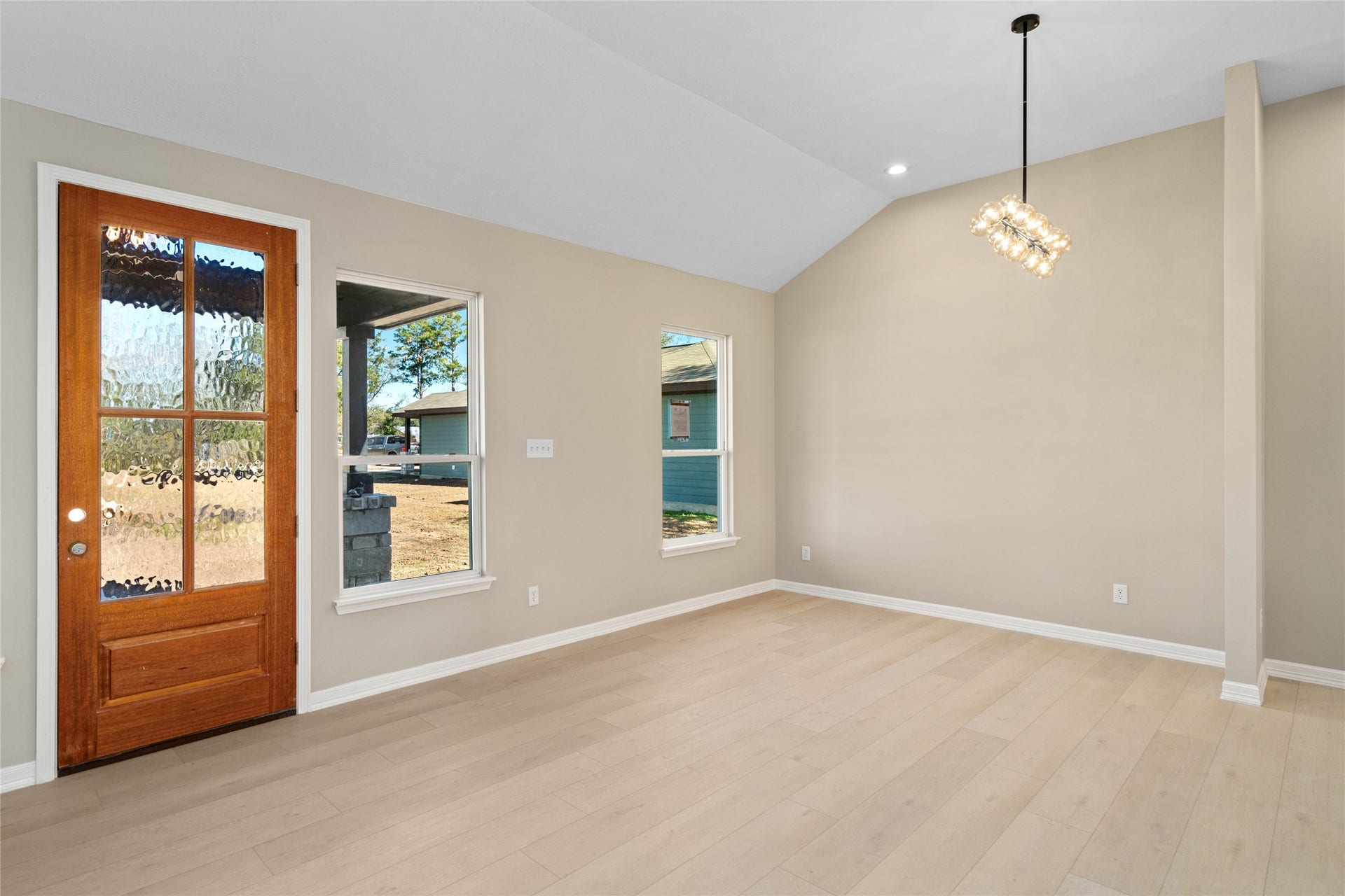 4656 N Teague Street, Rosharon, TX 77583 Bright and welcoming entry
view featuring a rich wood
front door with glass panels.
Natural light streams through
side windows, highlighting
the airy, modern living room.