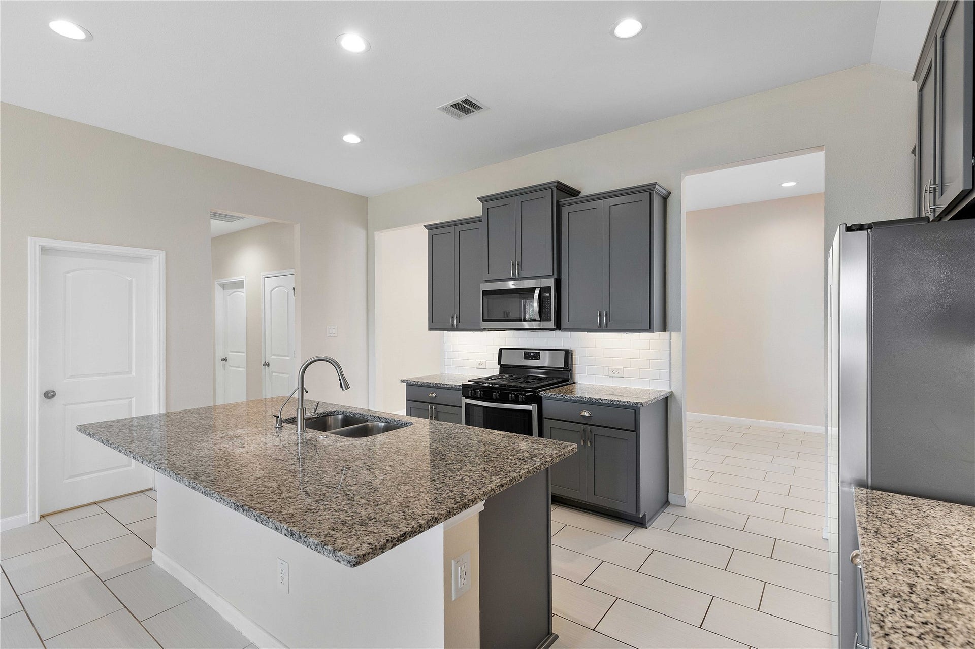 Discover the heart of the home with this spacious kitchen, featuring a sleek island perfect for culinary creations and gatherings.