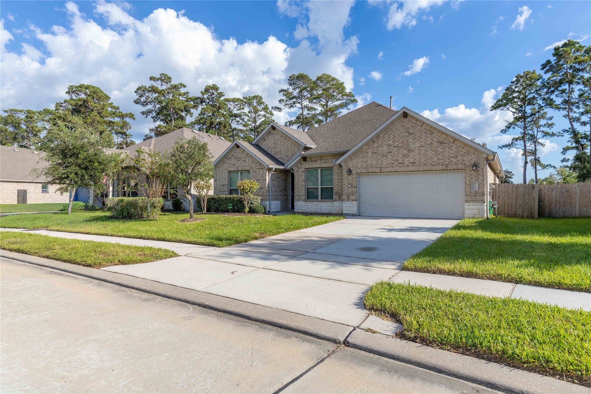 Charming single-story brick home with a spacious two-car garage, nestled in a peaceful neighborhood. Lush front lawn and mature trees provide excellent curb appeal.
