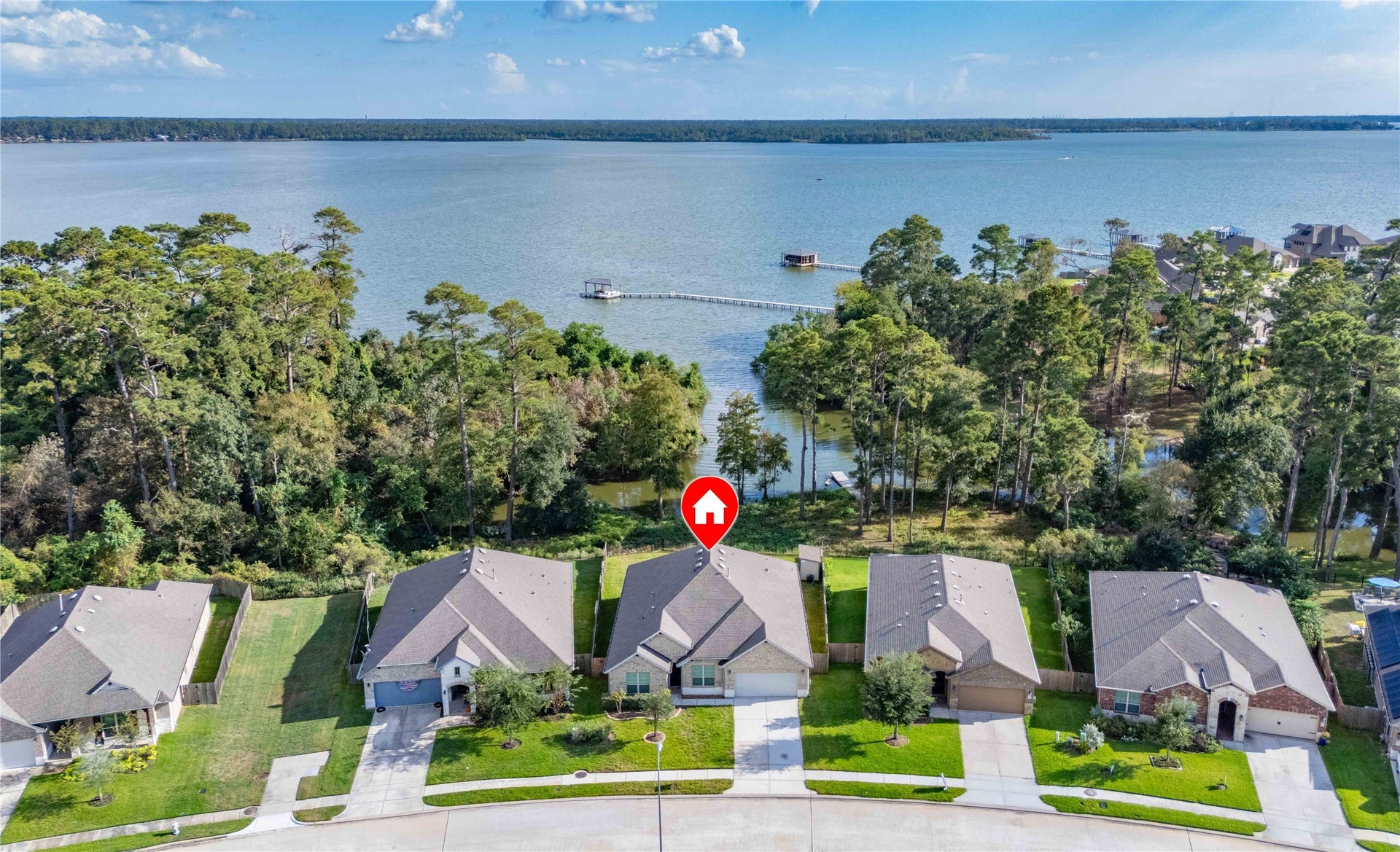 Charming waterfront home with stunning lake views, nestled among mature trees for privacy and tranquility.
