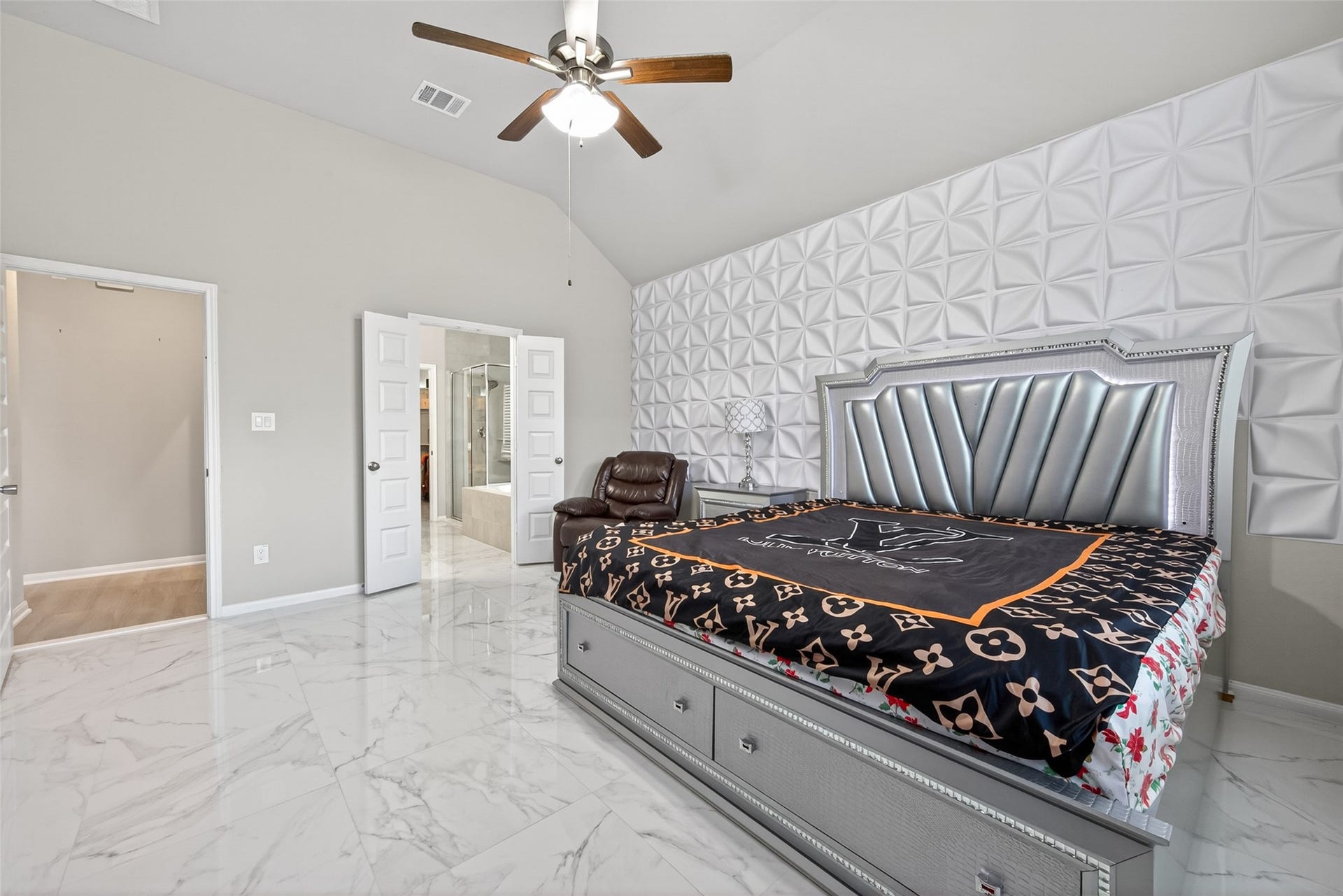 22409 Kinley Street, New Caney, TX 77357 Spacious bedroom with elegant design, ample natural light from adjoining doors leading to a stylish en-suite bathroom.