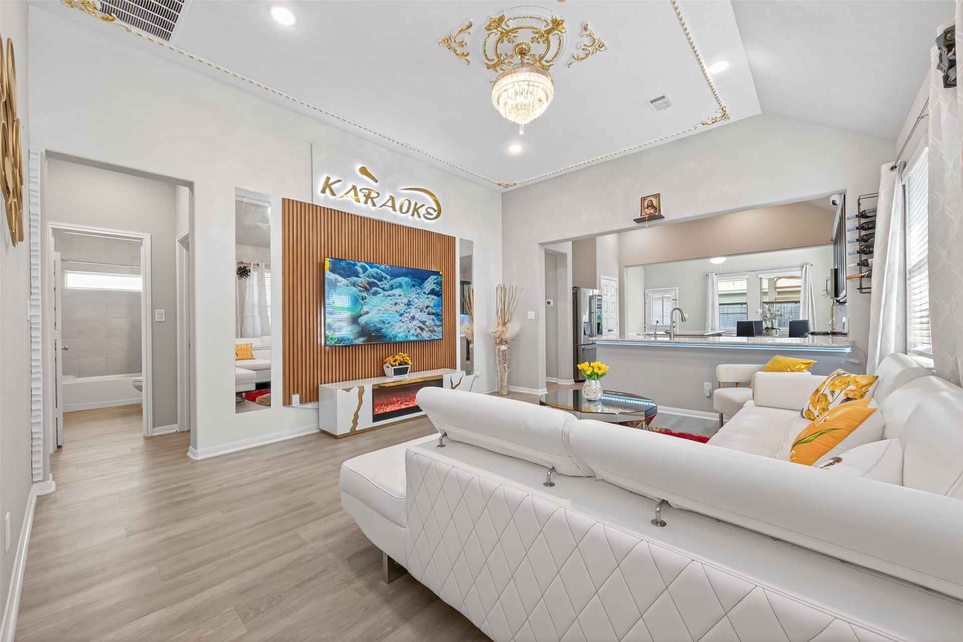 22409 Kinley Street, New Caney, TX 77357 Modern living room with an elegant chandelier, open layout, and a cozy seating area. Bright and inviting space with ample natural light.