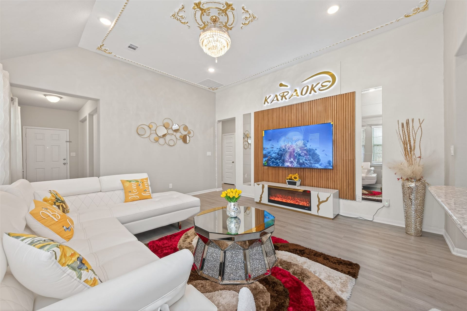22409 Kinley Street, New Caney, TX 77357 This stylish living room features a modern design with a cozy white sectional sofa. The space is perfect for entertainment, it offers a bright and inviting atmosphere.