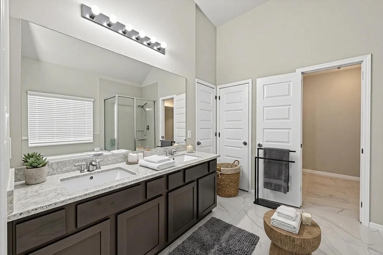 22409 Kinley Street, New Caney, TX 77357 This digitally staged bathroom offers a blend of modern elegance and functional design, featuring sleek countertops, a spacious shower.