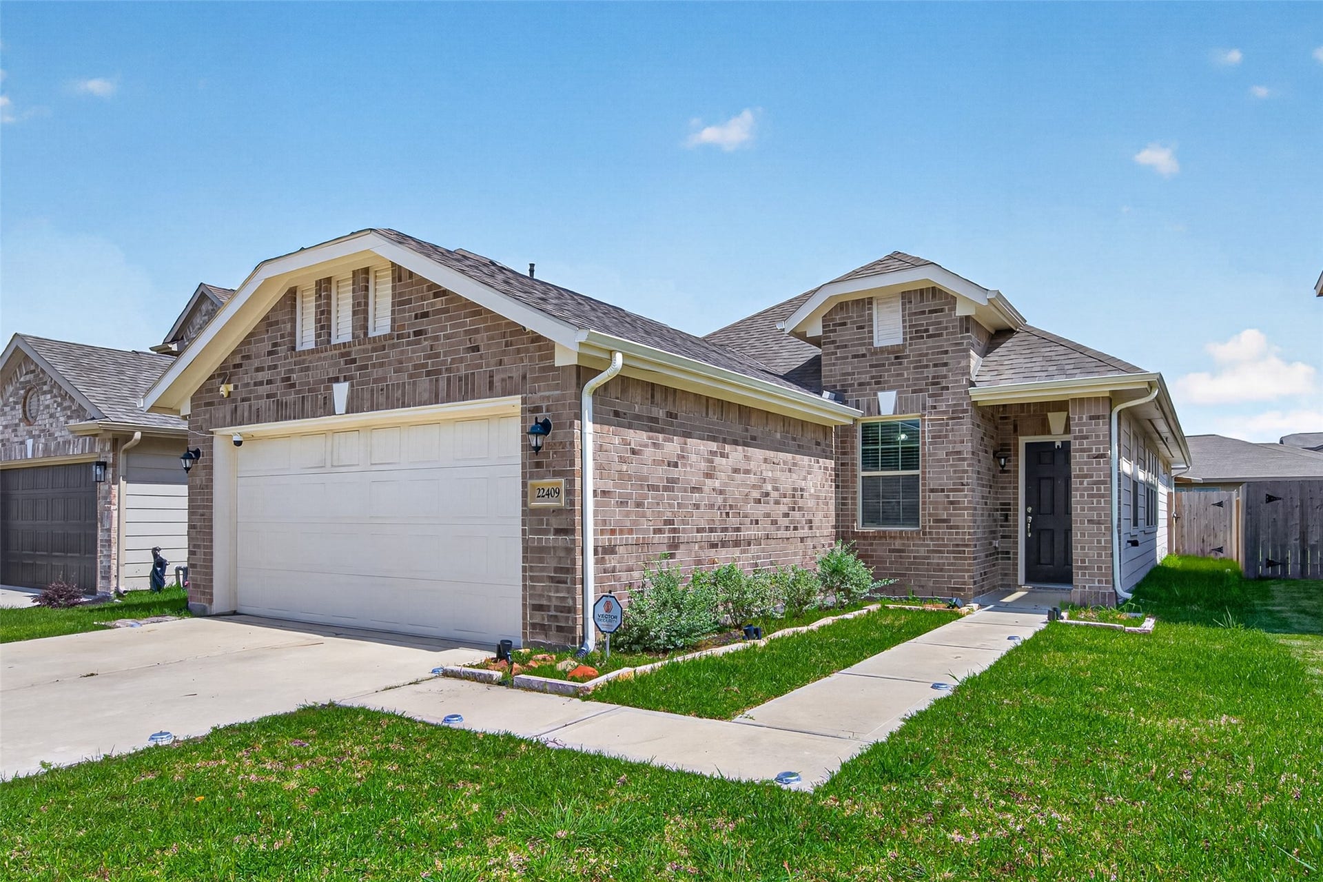 22409 Kinley Street, New Caney, TX 77357 Welcome to your new home at 22409 Kinley Street! A charming single-story brick home with a two-car garage, neat landscaping, and a welcoming front porch.