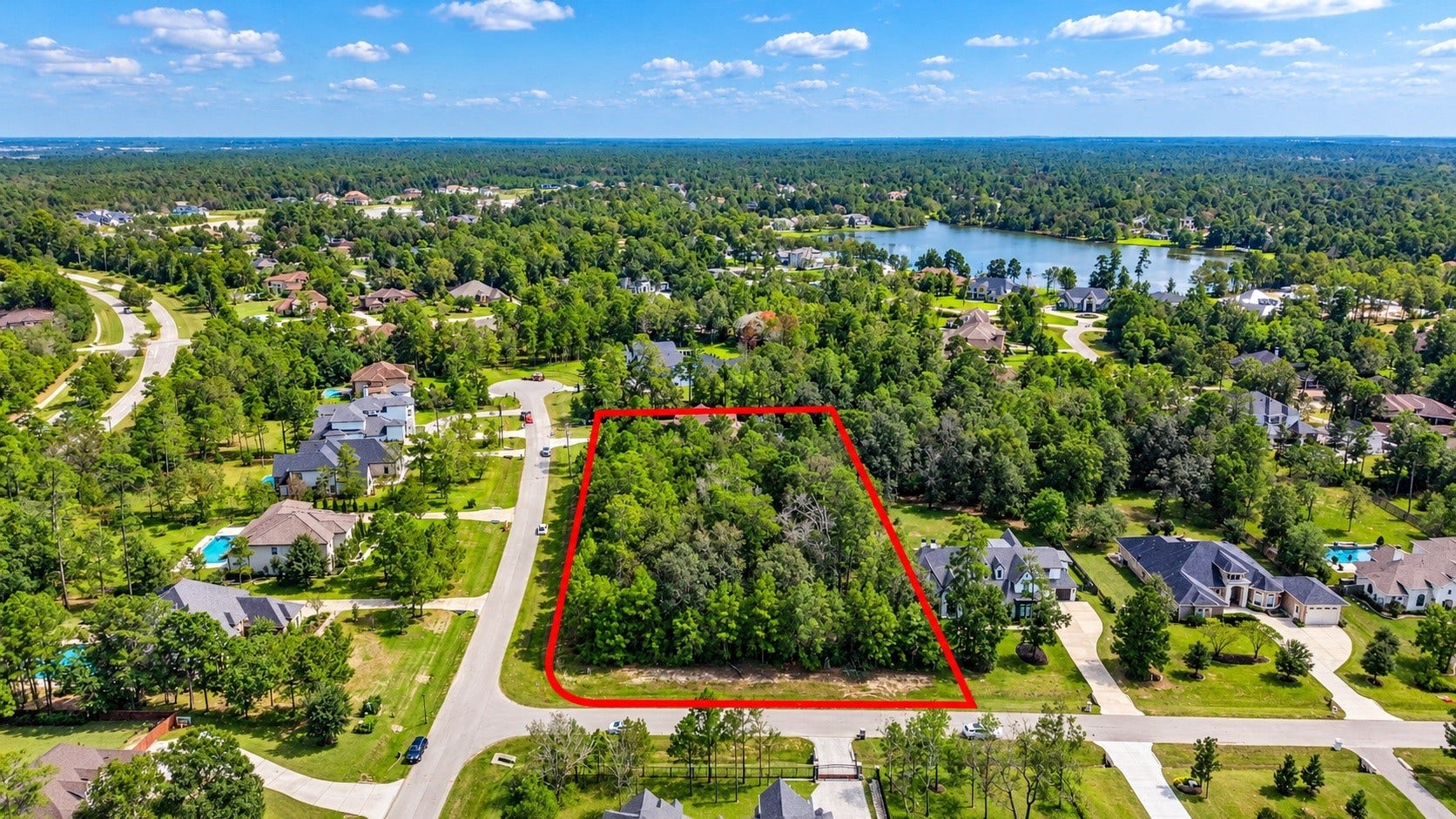 Aerial view outlining the homesite with ample space for a custom residence, pool, and outdoor living.