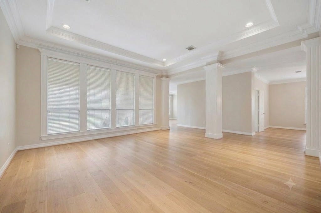 Living room. Virtual rendition with light colored hard wood floors and no drapes.