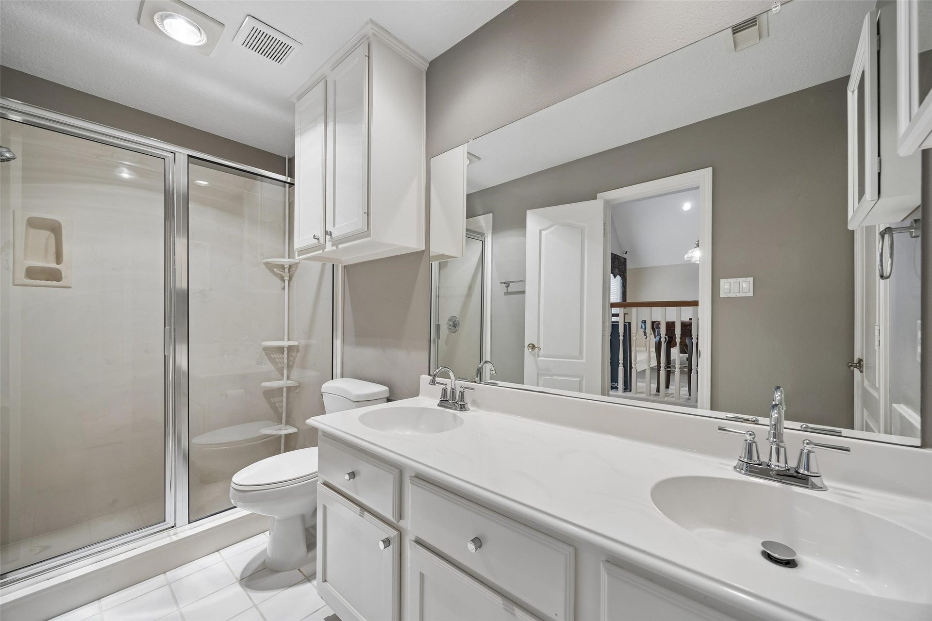 Second ensuite hall bathroom upstairs with glass enclosed shower