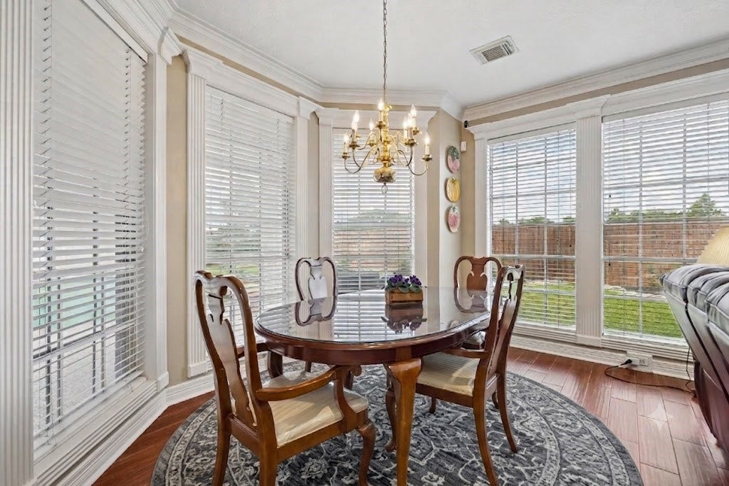 The breakfast room has views of the pool and backyard and is adjacent to the family room and kitchen. The table and chairs are available too.
