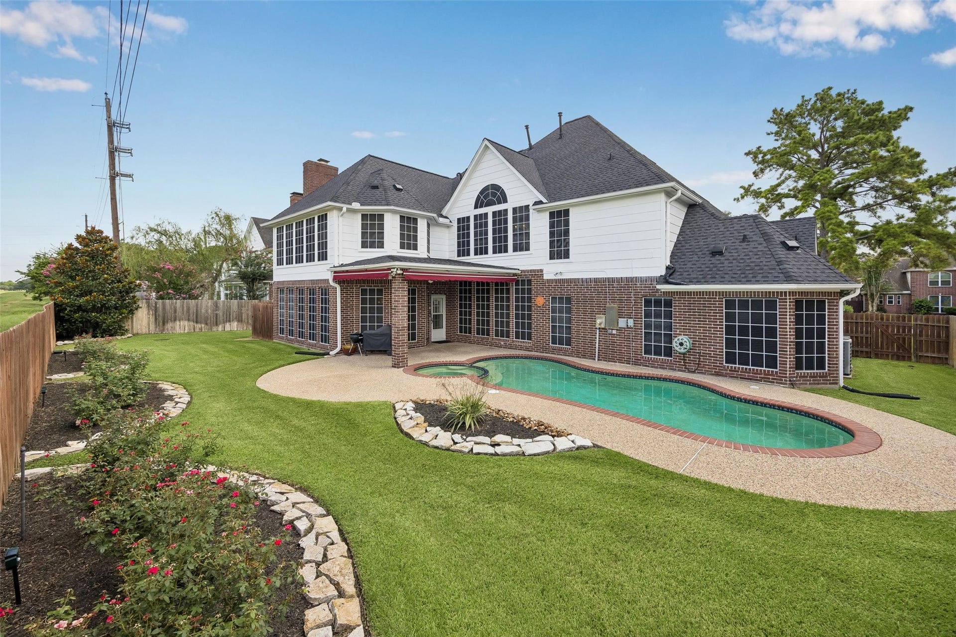 Experience outdoor luxury with this stunning backyard featuring a sparkling pool, spacious patio, and beautifully landscaped garden. The awnings are motorized expanding the living area. You will never have backyard neighbors.