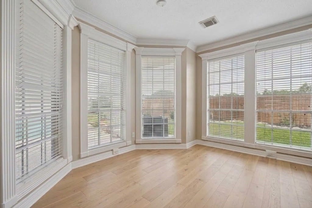 Breakfast room. Virtural rendition with light colored hard wood floors and no light fixture.