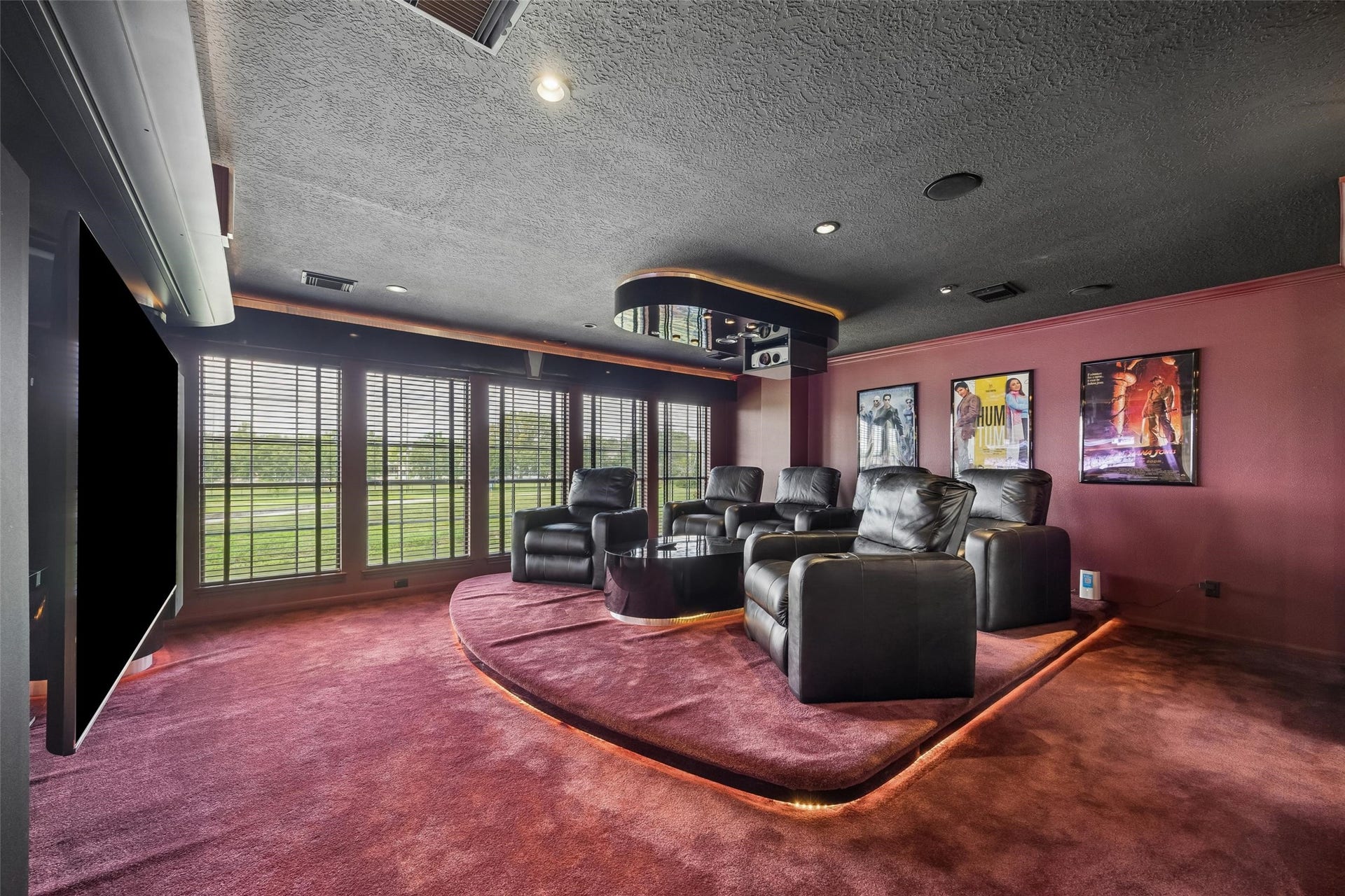Completely sound-proofed, vibration-proofed room, luxurious home theater featuring plush leather recliners, ambient lighting, and a large 100" TV screen, perfect for entertainment.