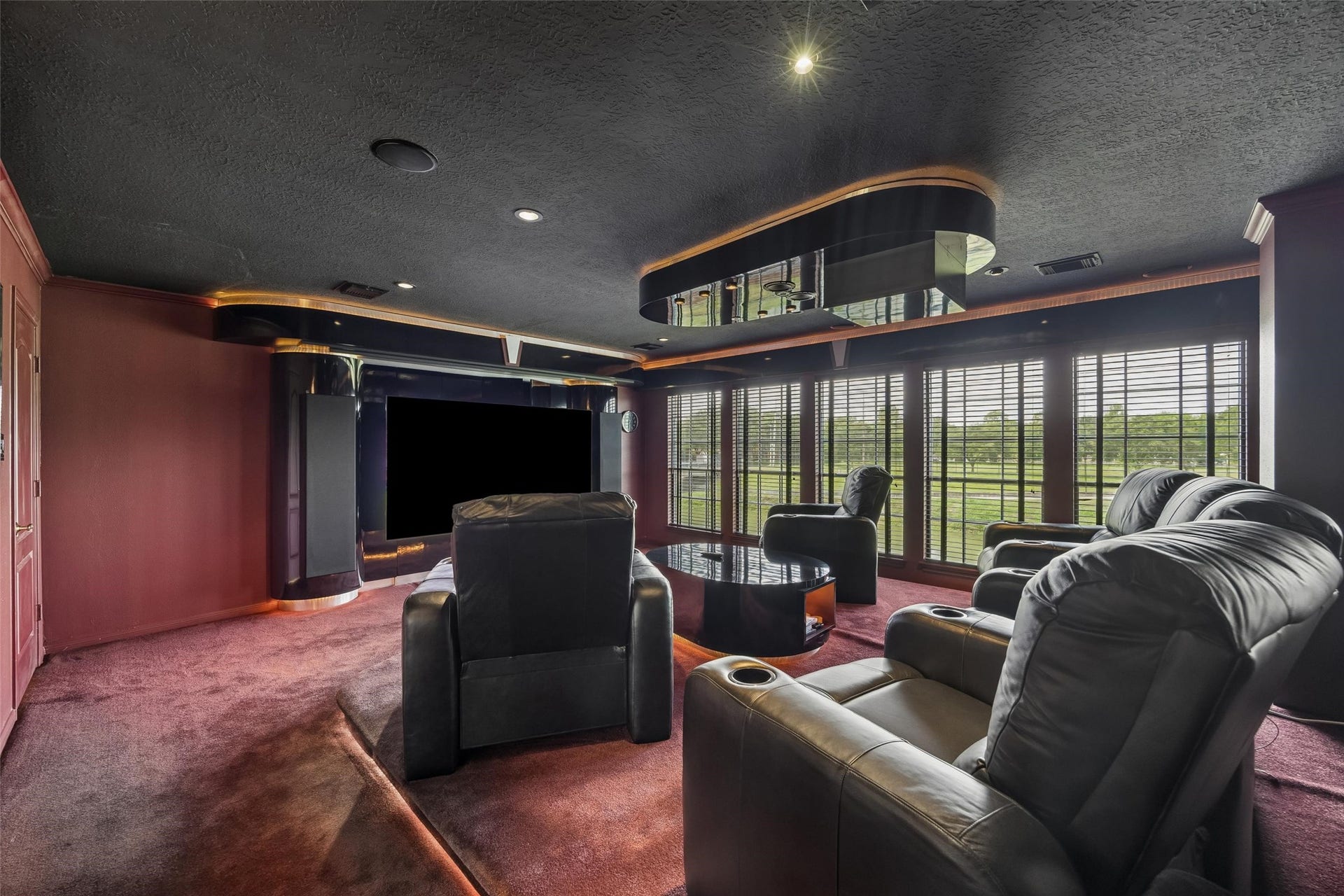 Some interesting things that makes this home unique is the luxurious home theater fully sound-proofed, featuring plush leather recliners, ambient lighting, and expansive windows offering scenic views. Besides the 100" TV there is a pull-down screen and projector option. Everything you see stays with the home.