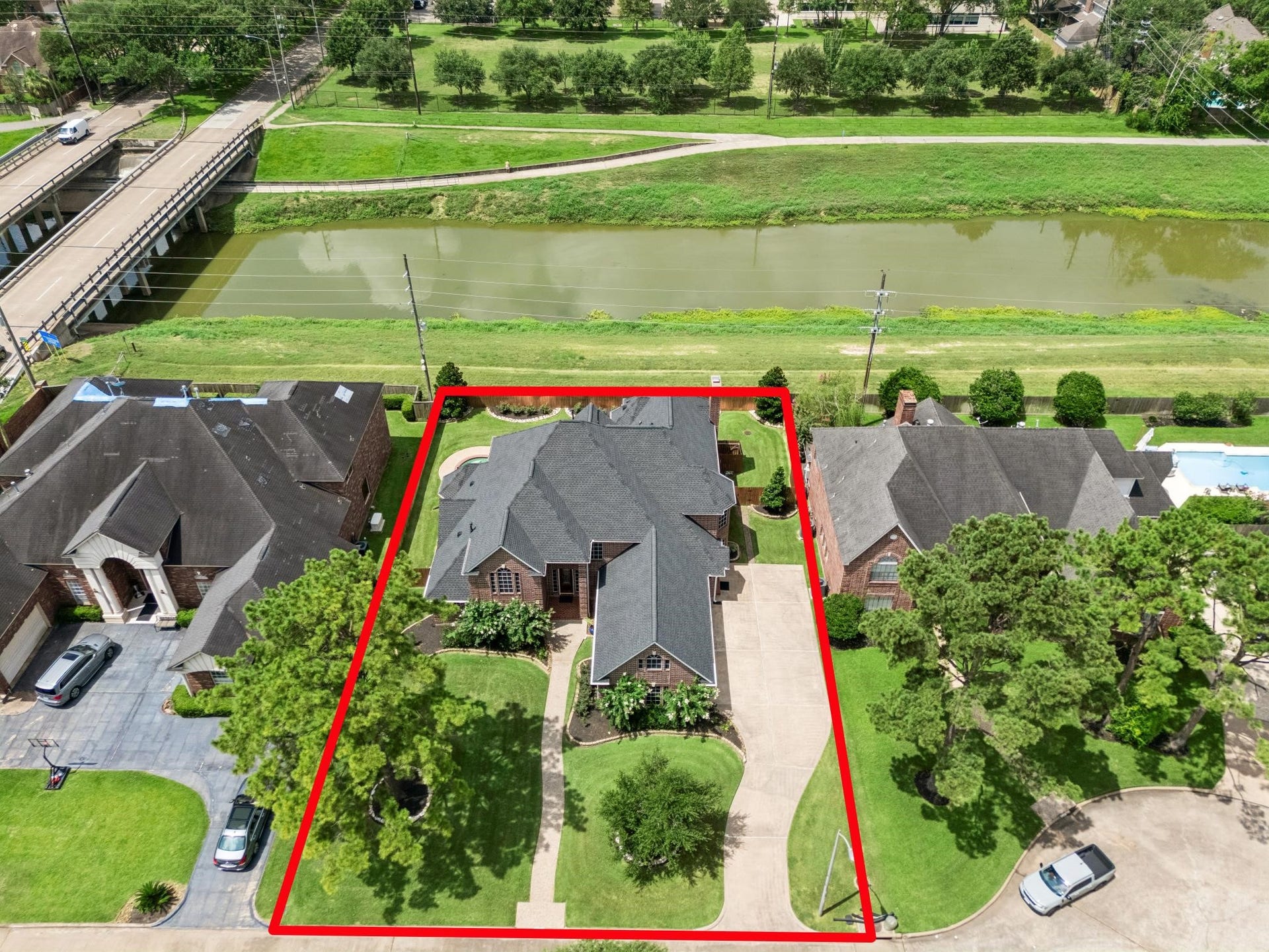 Stately brick home with a welcoming entrance, manicured lawn, and charming landscaping, nestled in a serene neighborhood setting.