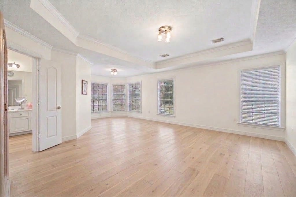 Primary bedroom. Virtual rendition with light colored hard wood floors. This room has a large sitting area that can be a home-office.