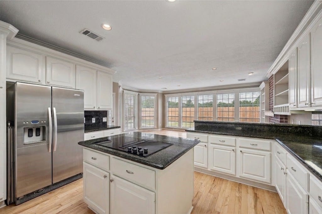 Kithen. Virtual rendition with light colored hard wood floors and no light fixture.