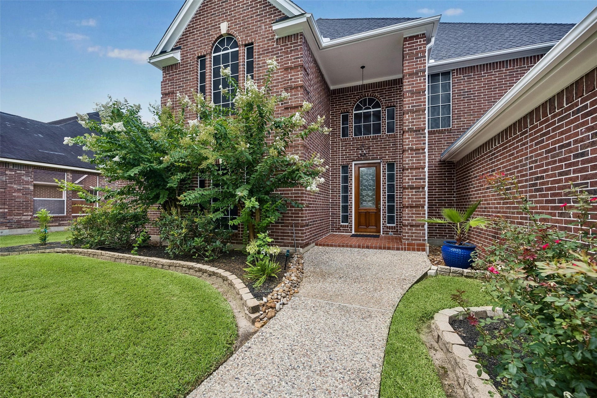 Builder's model home with lush greenery, nestled in a serene neighborhood offering privacy and picturesque views.