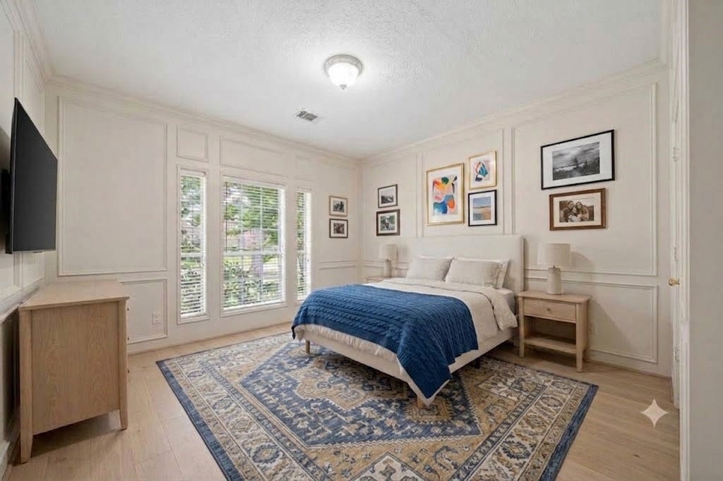 Bedroom or study with a closet. Virtual rentition with painted walls and light colored hard wood floors.