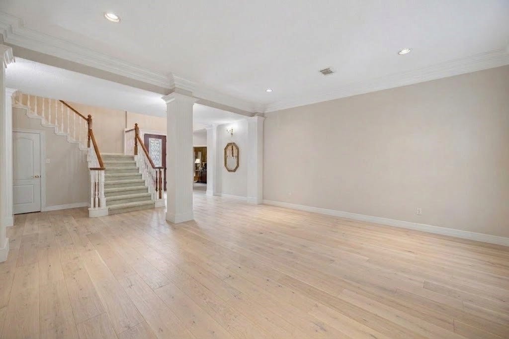 Living room looking at front entry. Virtual rendition with light colored hard wood floors.