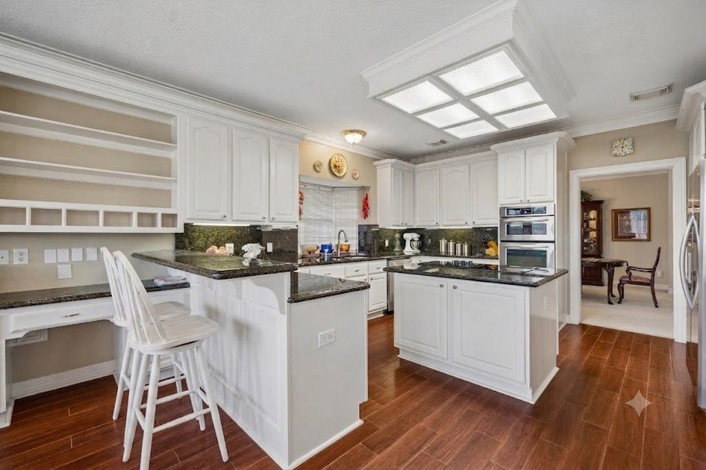 The kitchen has a new electric cooktop in this island and stainless appliances. The breakfast bar is a nice convience and is off the family room.