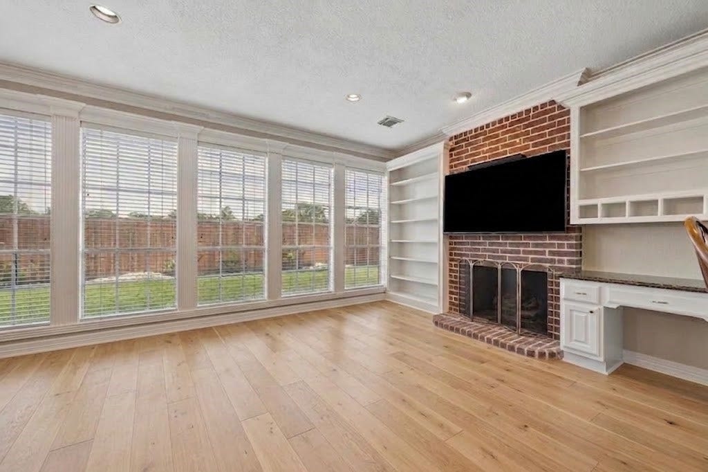 Family room off of kitchen. Virtual rendition with light colored hard wood floors.