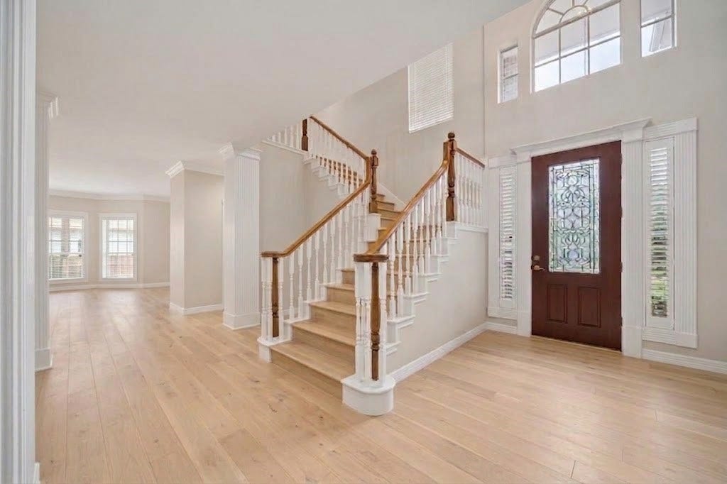 Welcome to your beautiful home. Foyer. Virtual rendition without the tile and carpet and added light colored hard wood floors.