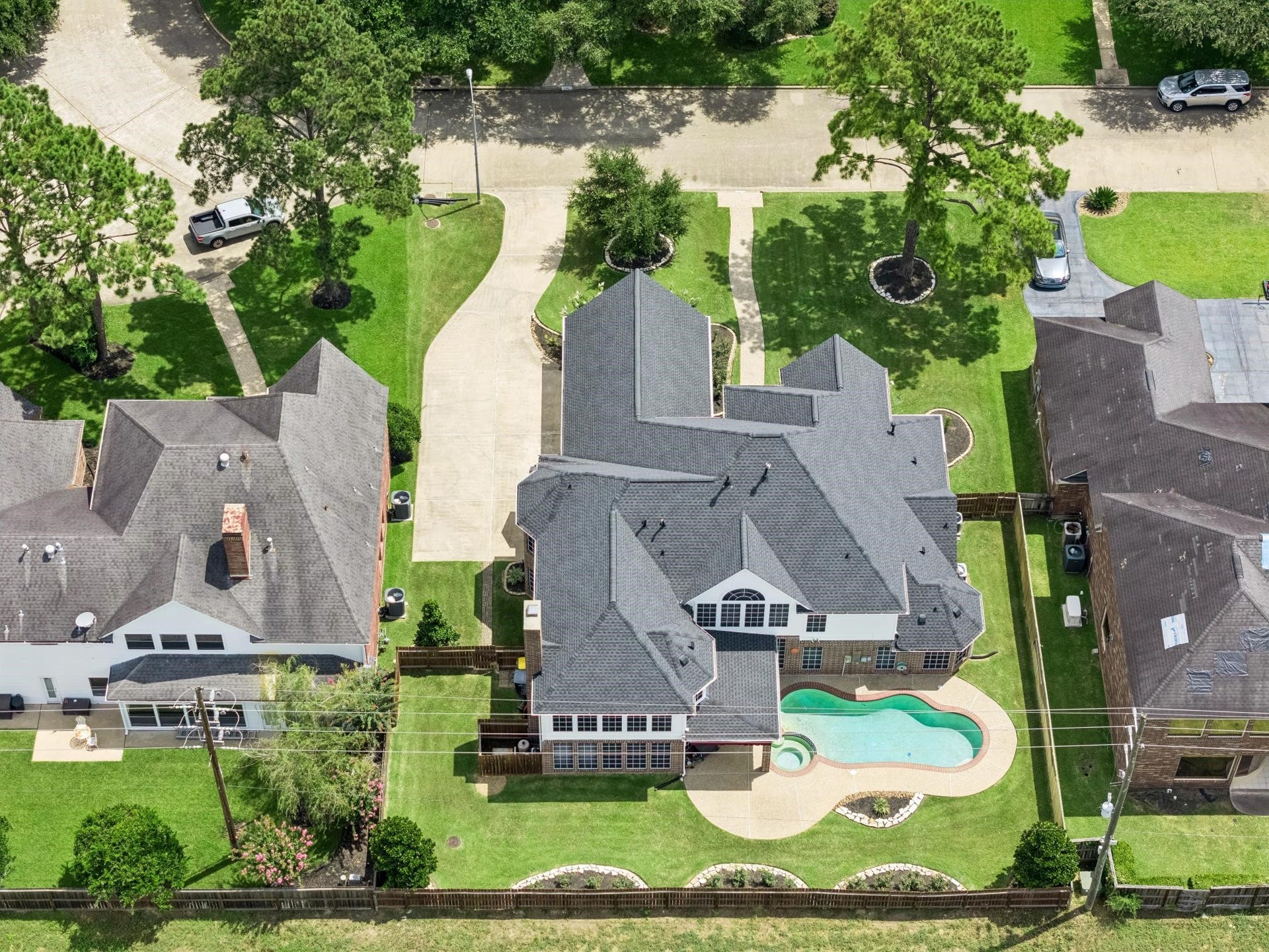 Spacious single-family home on a generous lot, featuring lush landscaping, a pool with a spa and a private driveway.