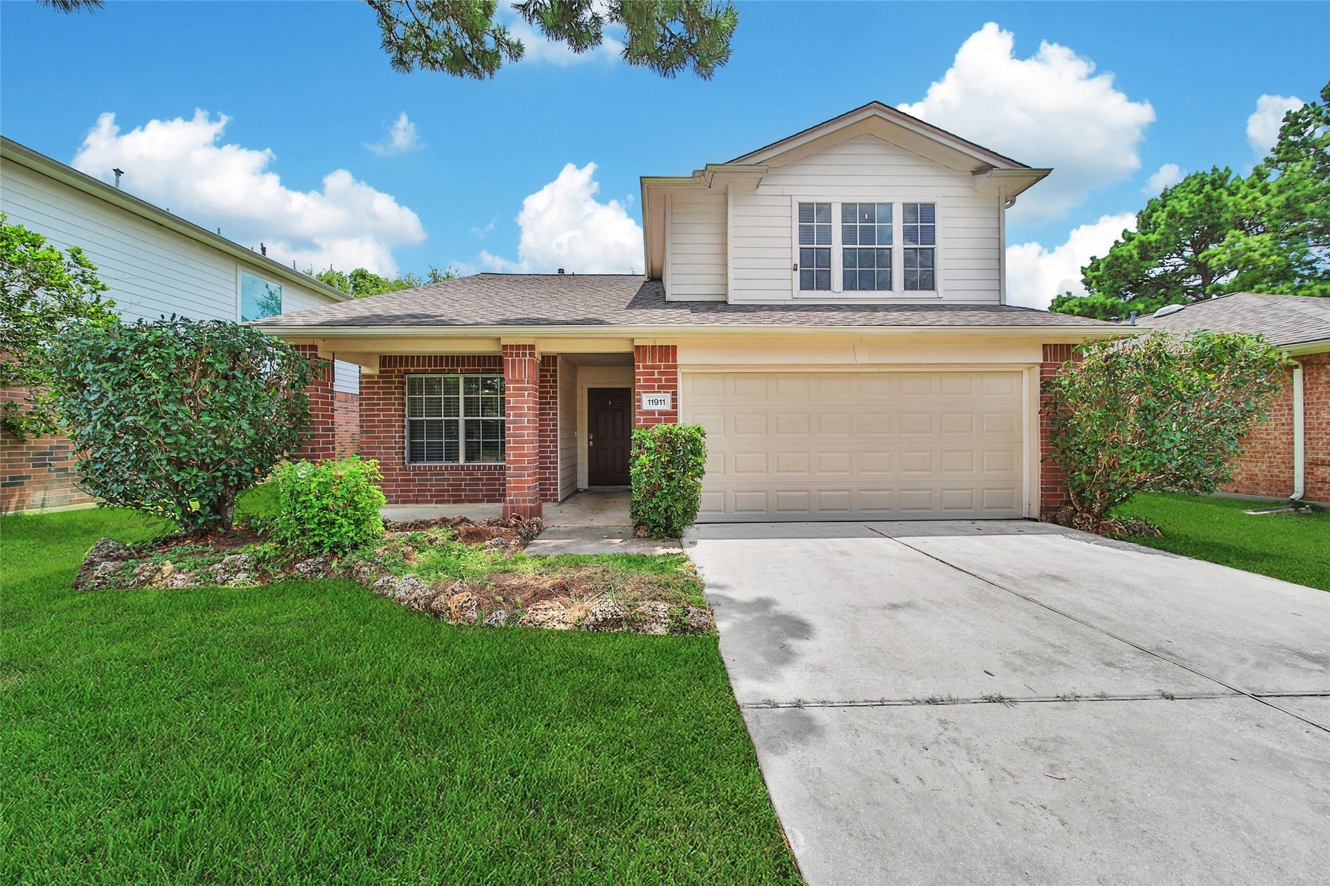 11911 Ezekiel Drive, Tomball, TX 77375 This property features a covered front porch and a two car attached garage.