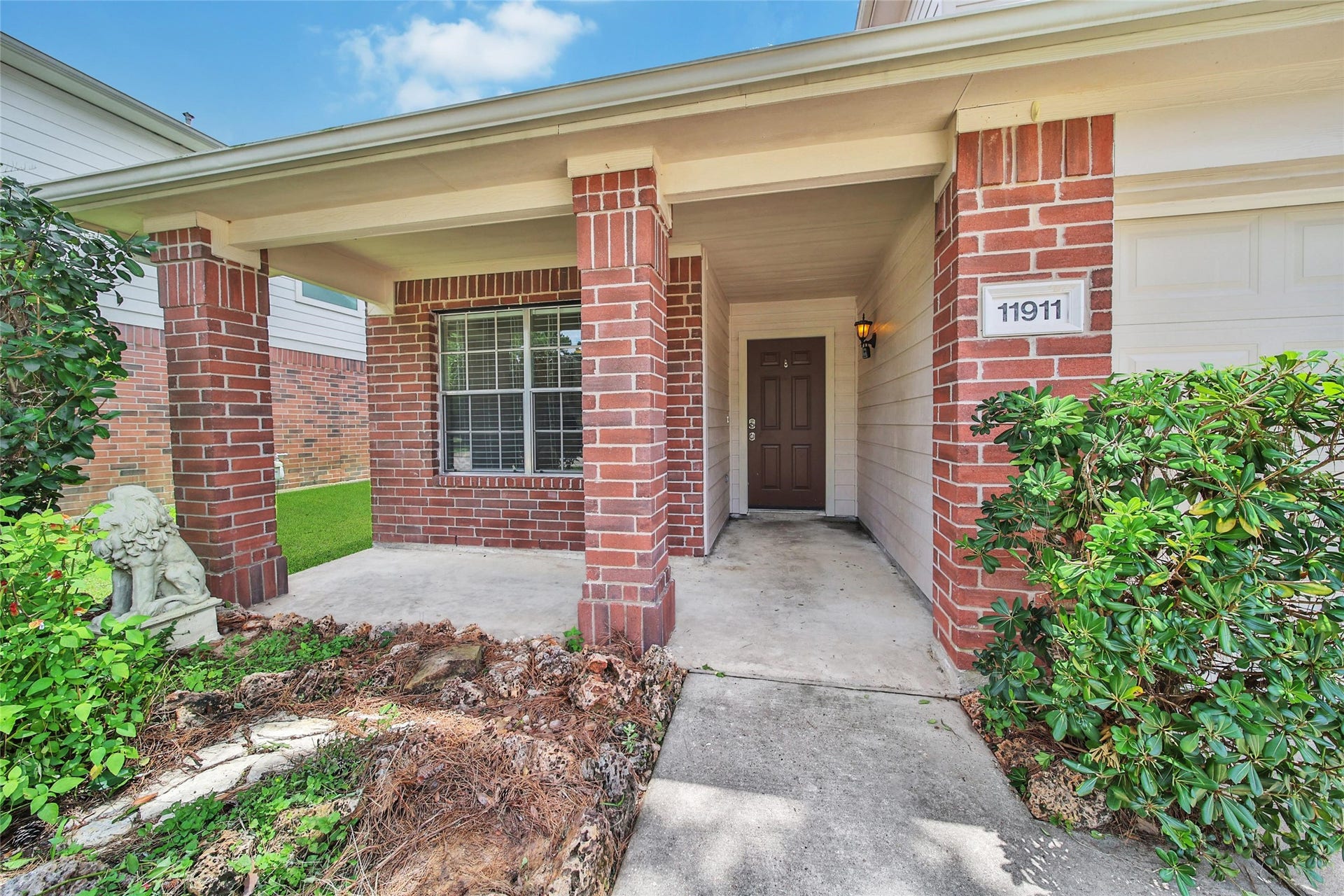 11911 Ezekiel Drive, Tomball, TX 77375 This property features a covered front porch and a two car attached garage.