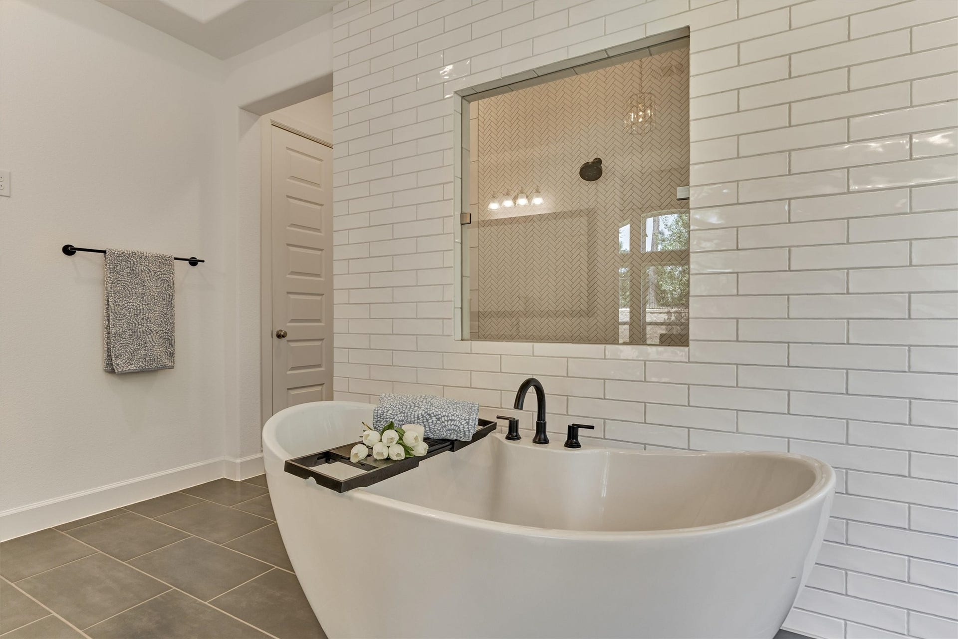 205 Patina Sorrel Drive, Montgomery, TX 77316 Luxurious bathroom featuring a freestanding tub, elegant subway tile accents, and modern fixtures, creating a perfect retreat for relaxation.