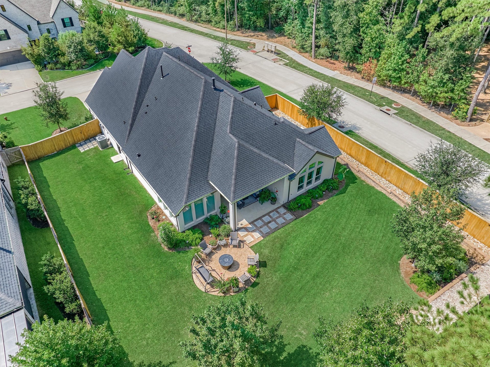 205 Patina Sorrel Drive, Montgomery, TX 77316 Expansive backyard with lush green lawn and a charming patio area, perfect for outdoor entertaining in a serene neighborhood setting.