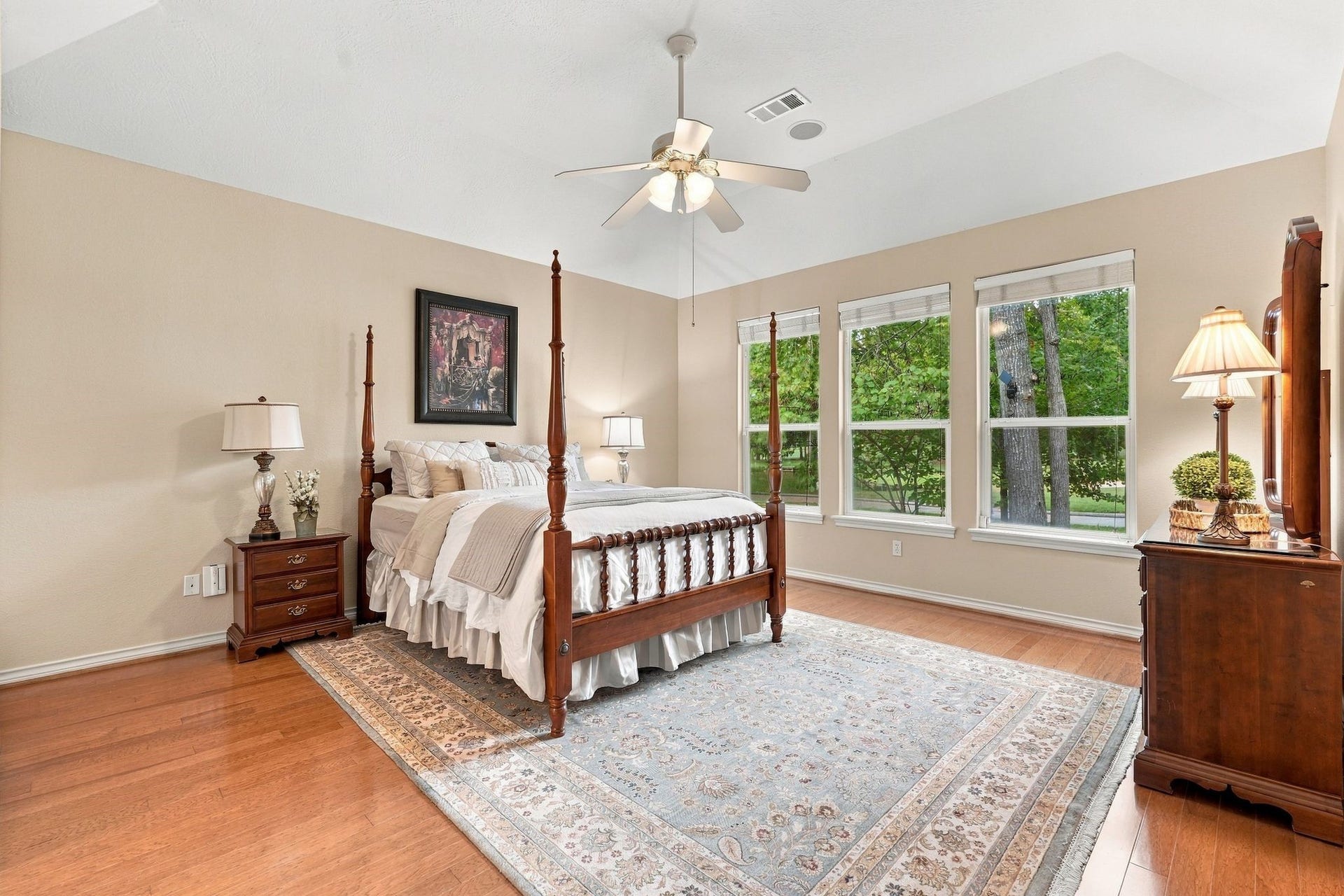 156 April Waters Drive W, Conroe, TX 77356 Primary Suite is so nice and spacious with windows facing the golf course 16th hole and water feature.