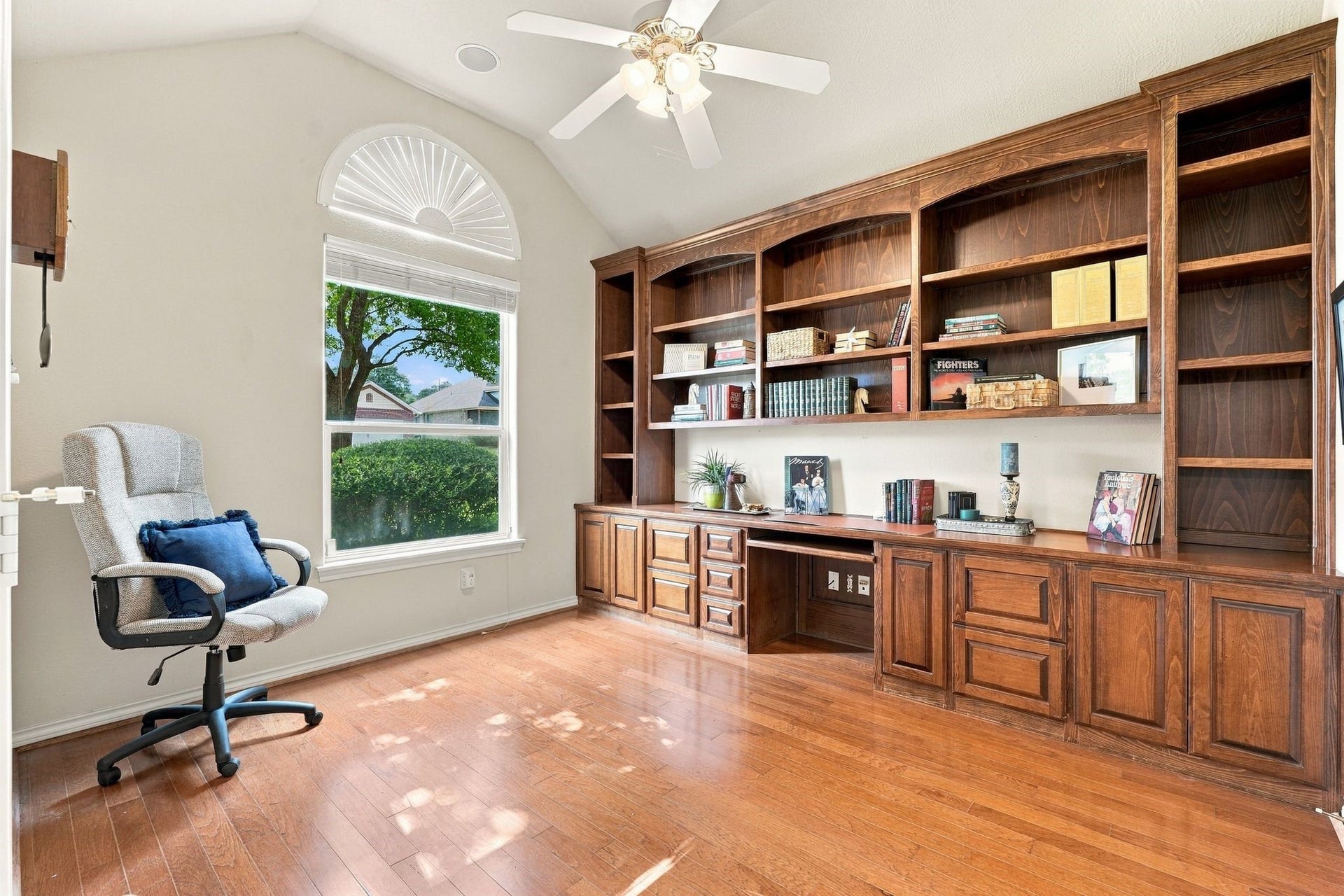 156 April Waters Drive W, Conroe, TX 77356 Spacious home office with custom built-in bookshelves, ample desk space, and room for a treadmill. Natural light enhances the space. This room can be used as a study, extra bedroom, craft room....your choice!