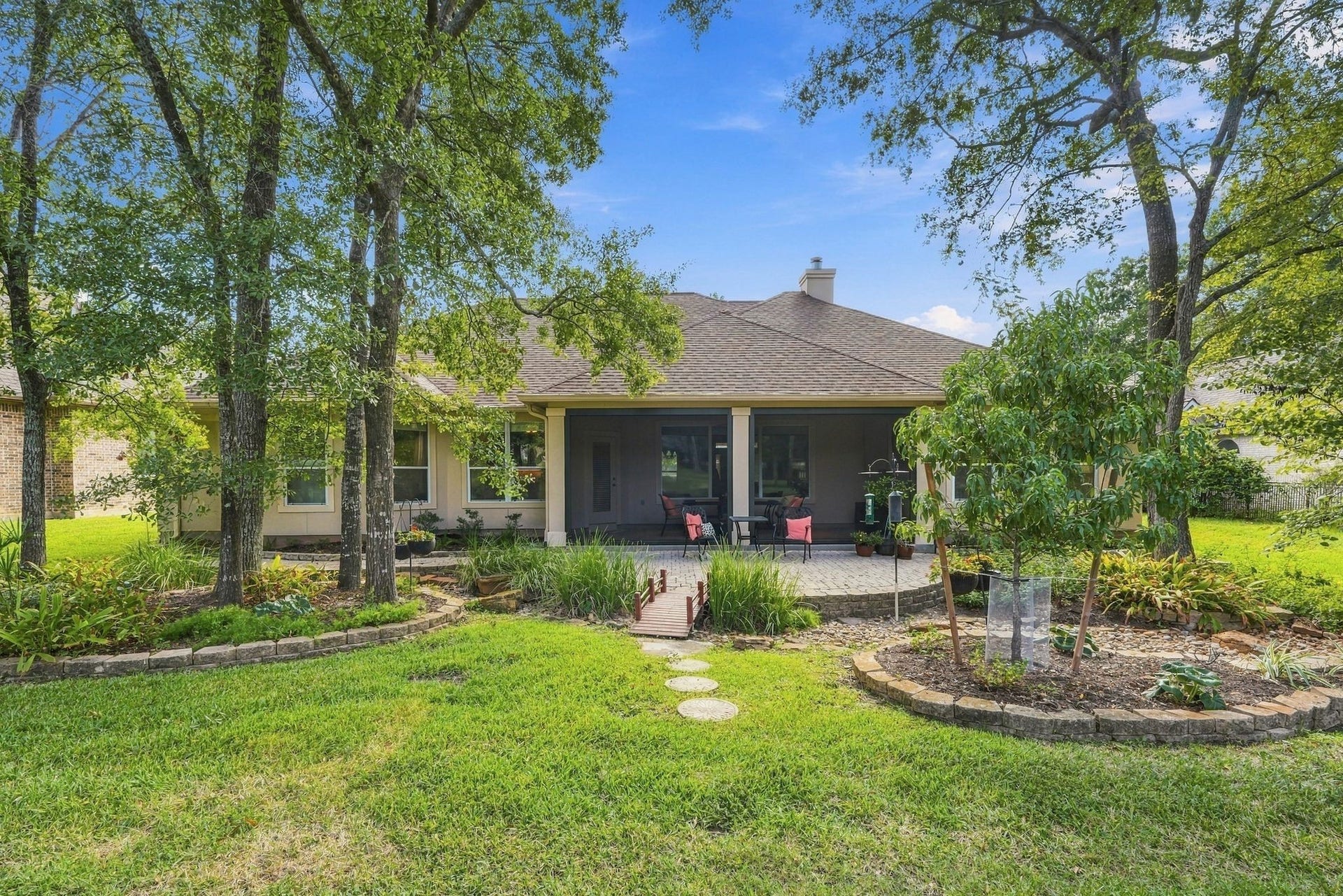 156 April Waters Drive W, Conroe, TX 77356 From the cart path a view of the back patio and porch.