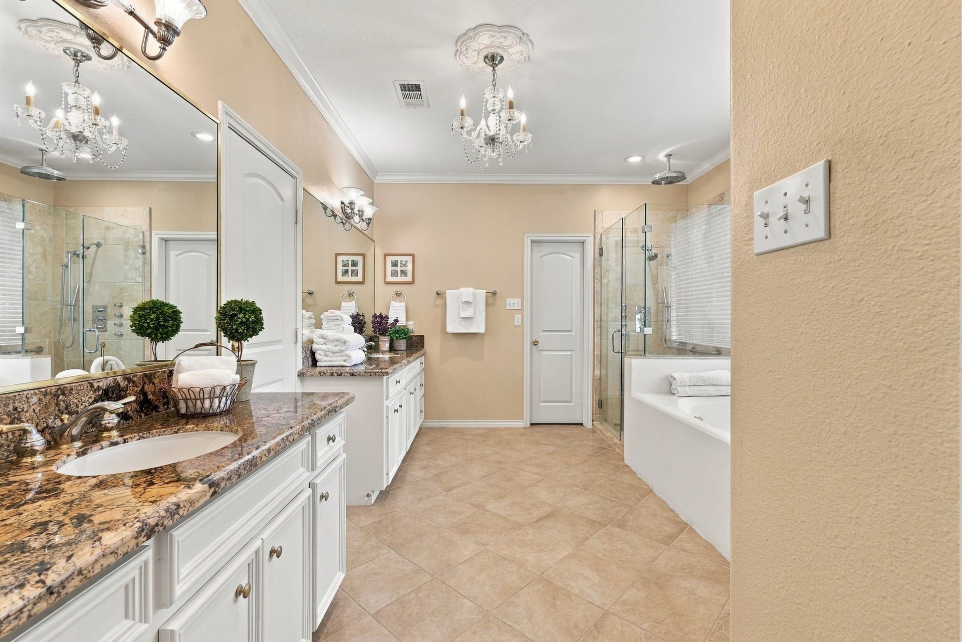 156 April Waters Drive W, Conroe, TX 77356 Primary en-suite bathroom has double vanities and 2 walk in closets. Notice the beautiful chandelier.