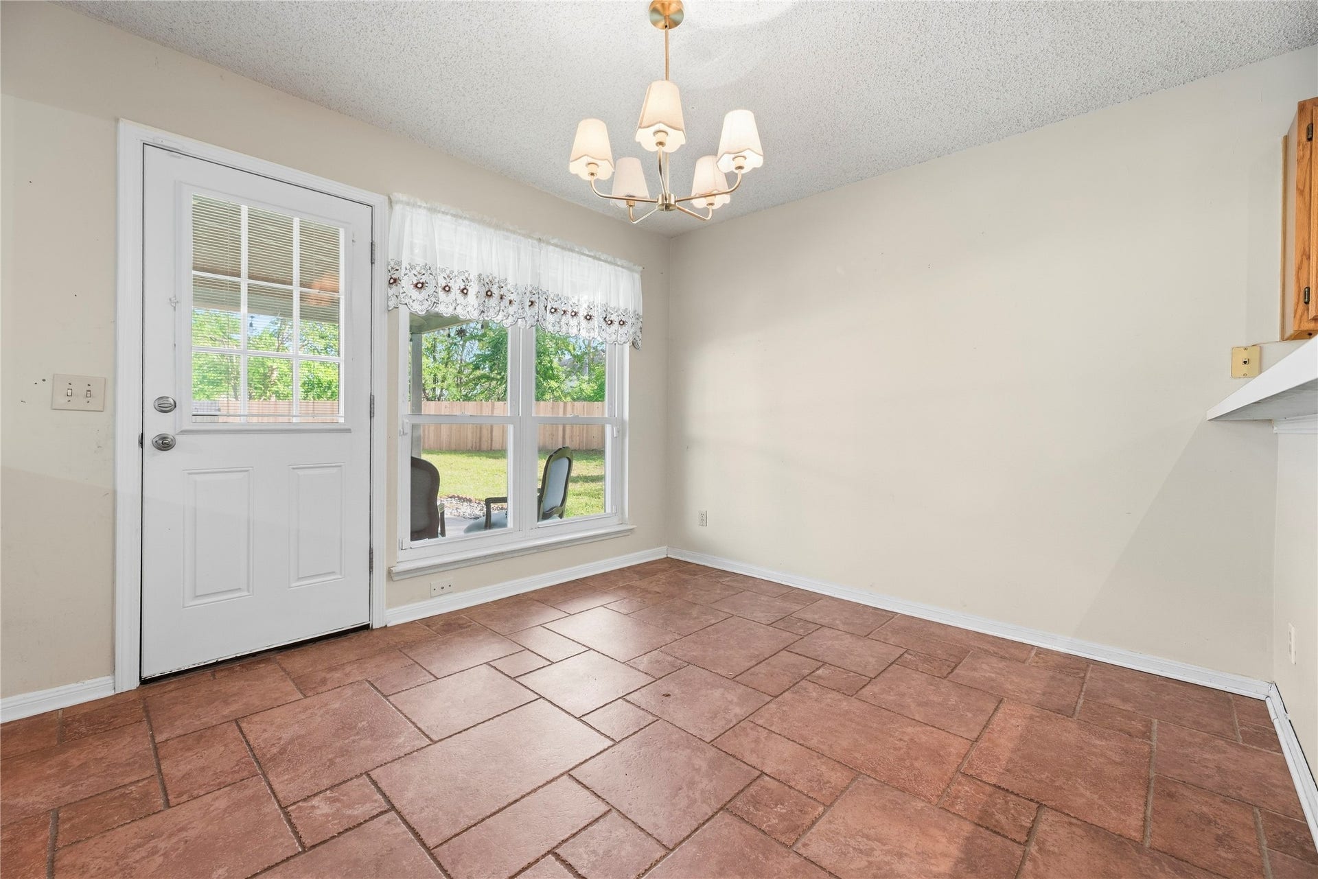 9922 W Cedaredge Drive, Houston, TX 77064 Bright breakfast area with terracotta tile flooring and large windows offering a view of the backyard.