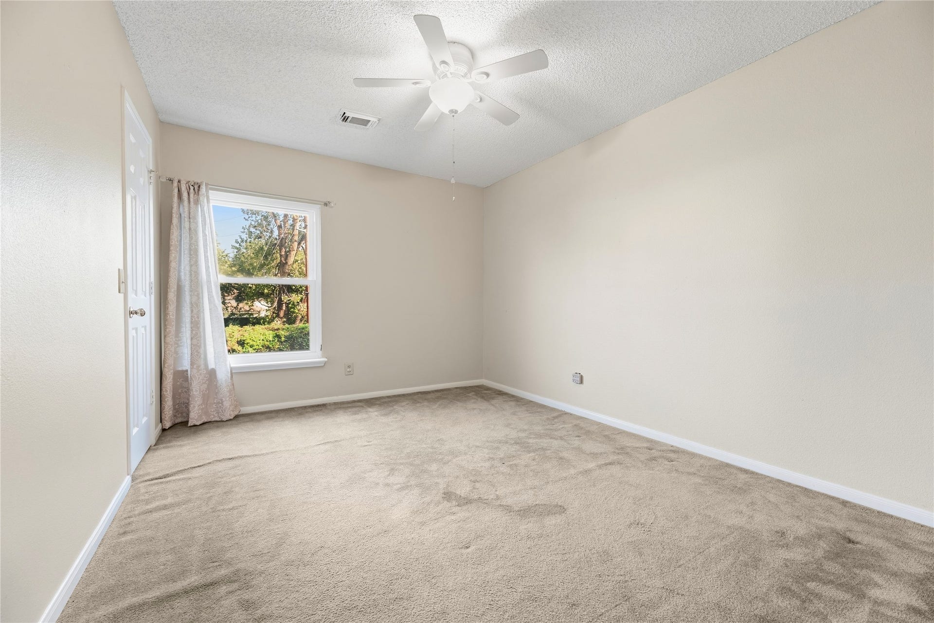 9922 W Cedaredge Drive, Houston, TX 77064 Secondary bedroom #2 is also bright and spacious with large window overlooking the backyard.