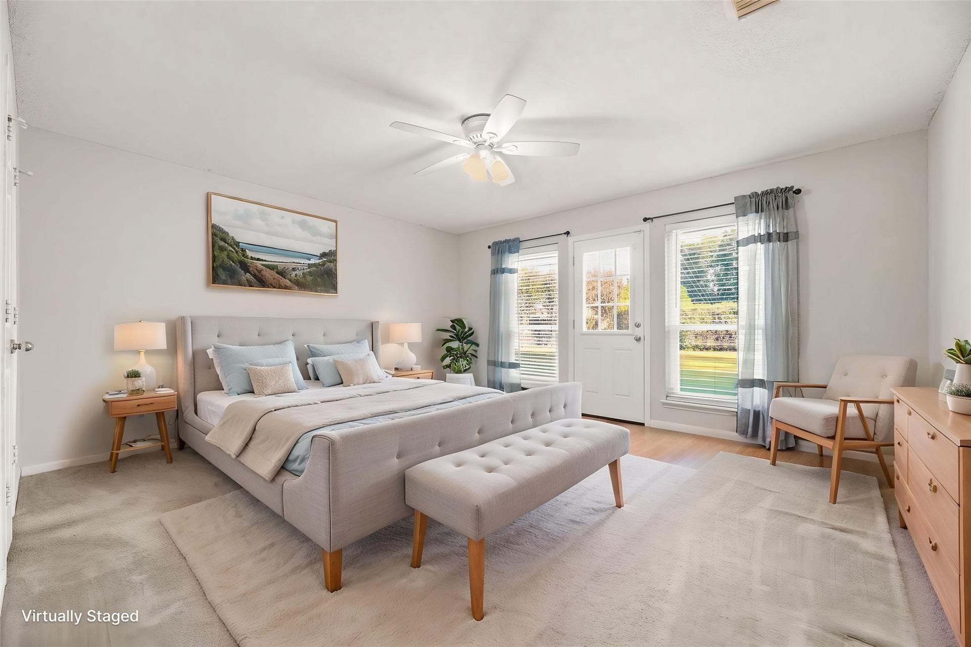 9922 W Cedaredge Drive, Houston, TX 77064 Virtually Staged -- Bright and spacious primary bedroom featuring a ceiling fan and double windows with a door leading to a serene outdoor view.