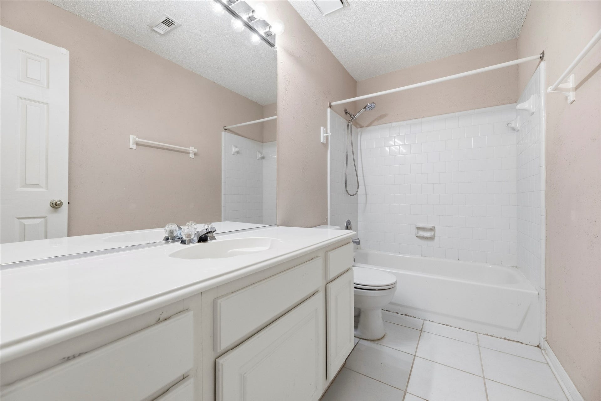 9922 W Cedaredge Drive, Houston, TX 77064 Bright and inviting secondary bathroom #2 featuring a spacious vanity, large mirror, and a classic shower-tub combination with clean white tiling.