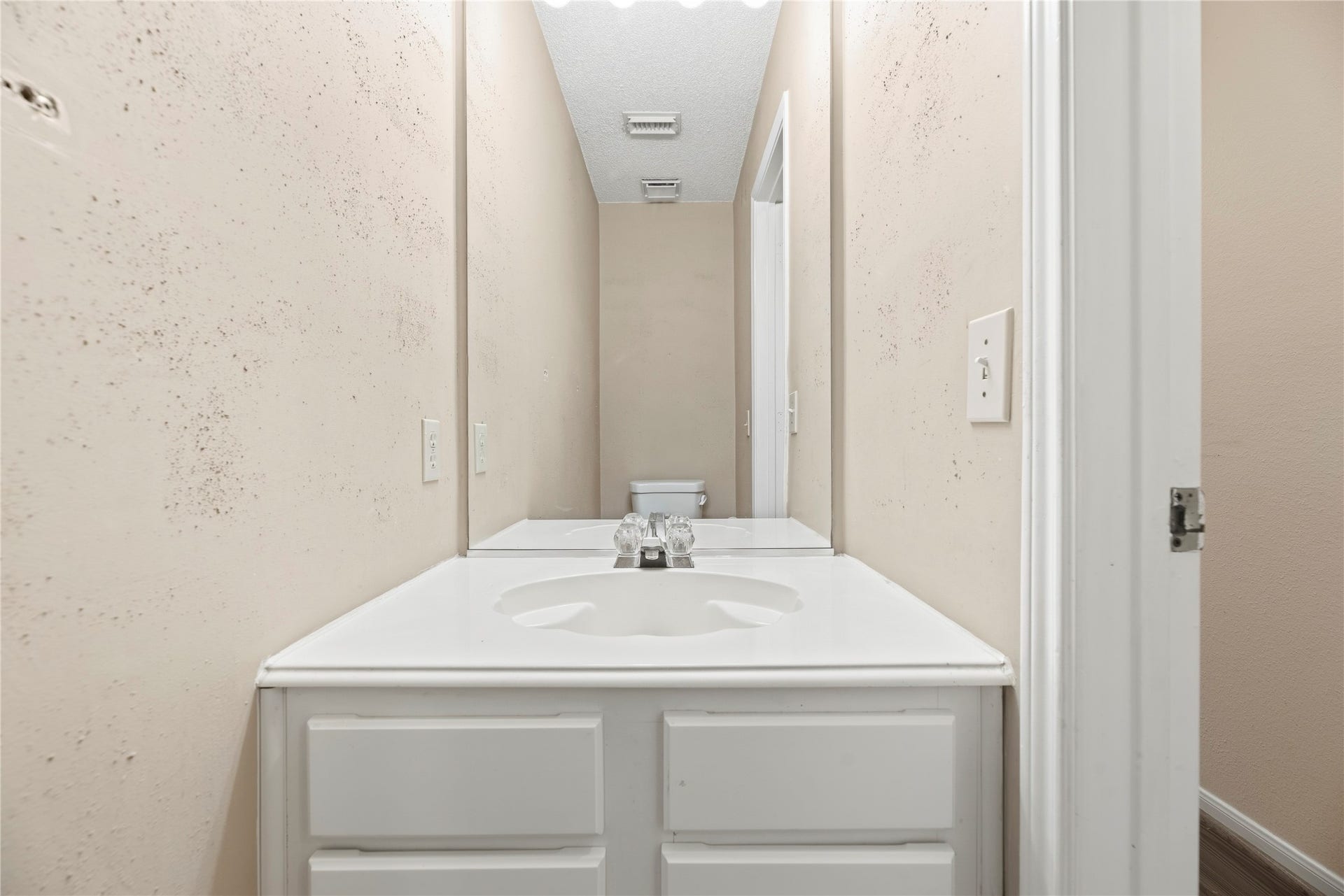 9922 W Cedaredge Drive, Houston, TX 77064 Bright and functional 1/2 bathroom located downstairs, featuring a sleek white vanity and modern fixtures, complemented by neutral walls for a fresh, clean look.
