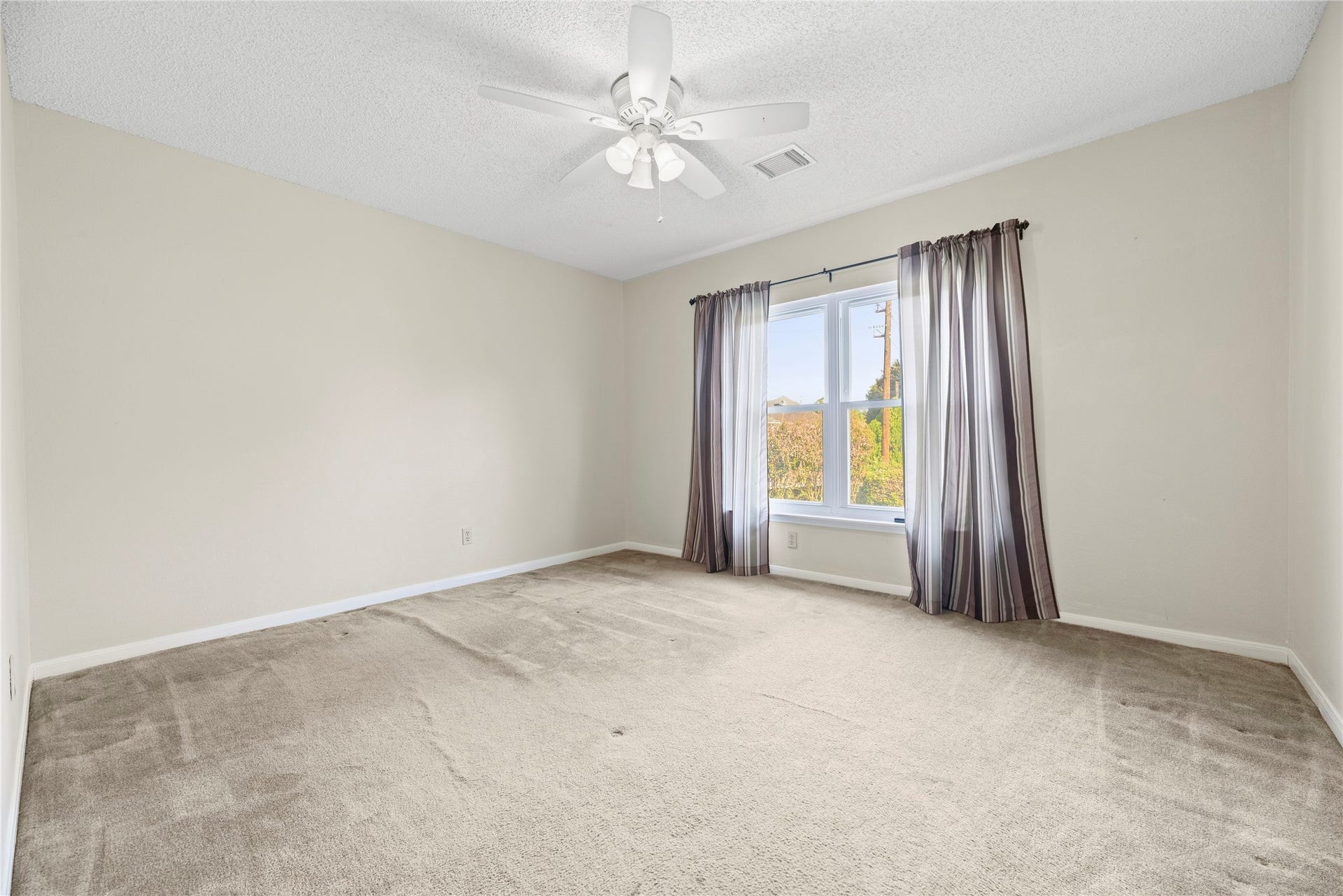 9922 W Cedaredge Drive, Houston, TX 77064 Bright and inviting secondary bedroom #1 featuring a large window with natural light for a relaxing atmosphere.