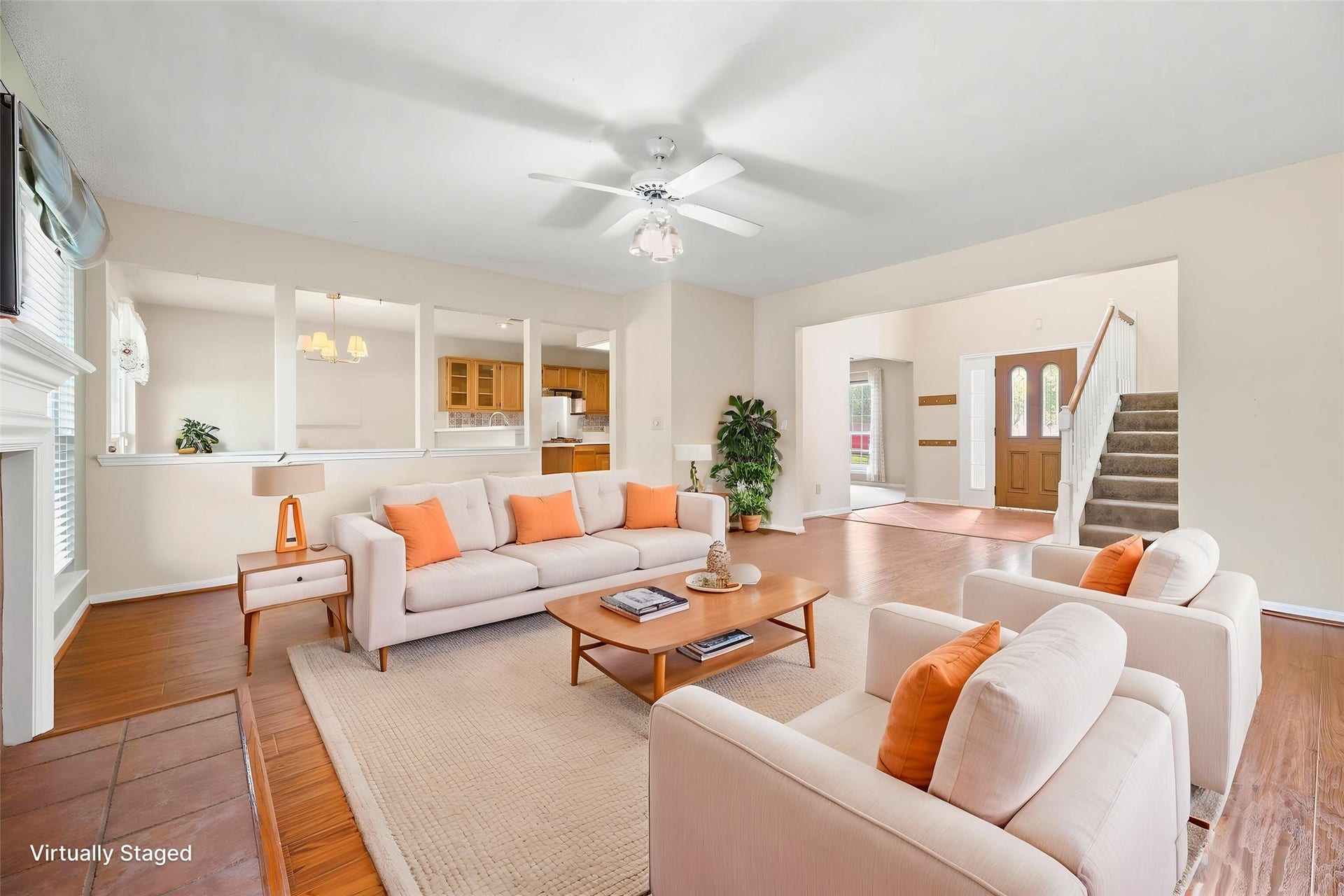 9922 W Cedaredge Drive, Houston, TX 77064 Virtually Staged--Spacious living area with rich wood flooring, a ceiling fan, and an open layout connecting to the kitchen and breakfast space.