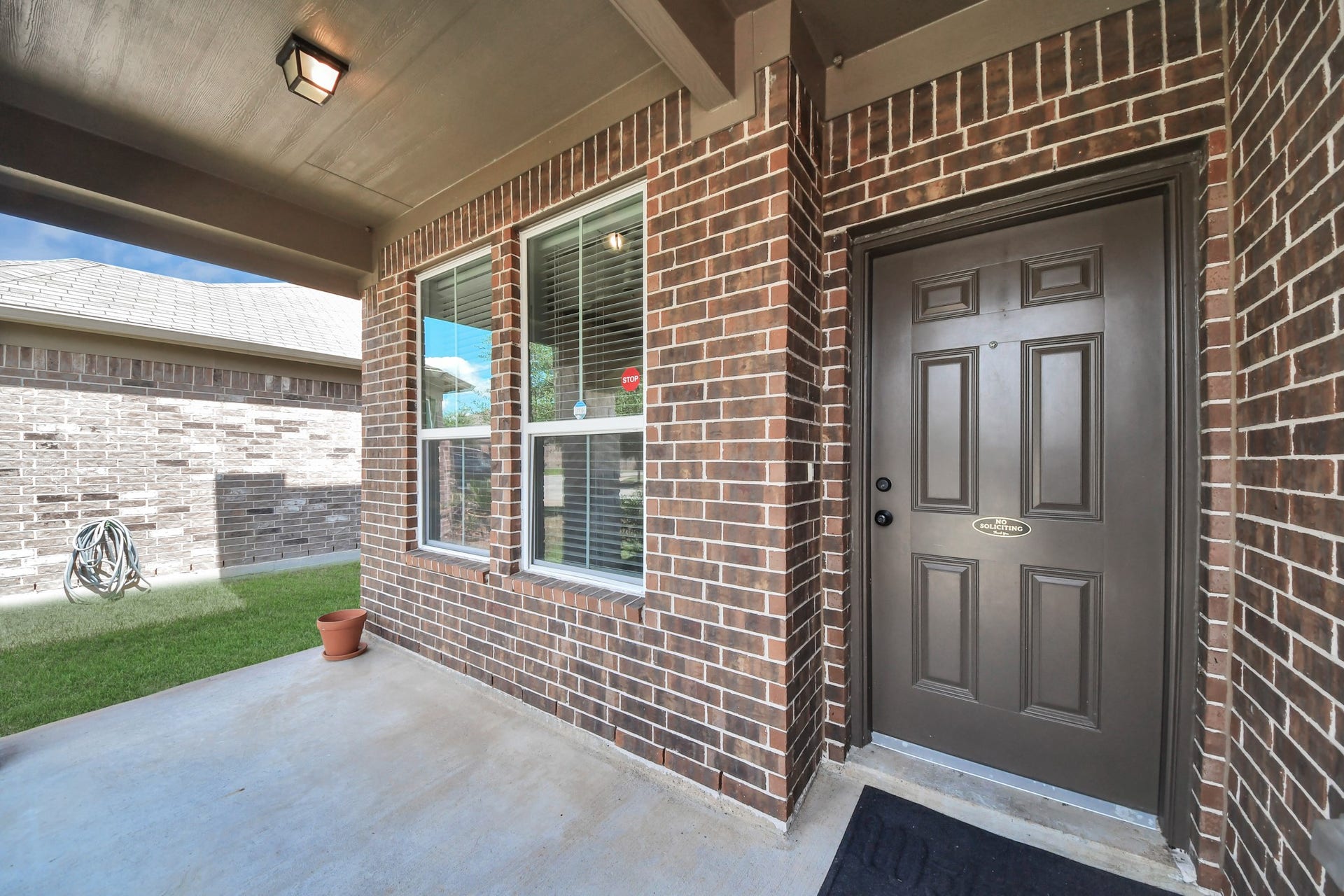 Welcoming covered front porch with a private, recessed entryway.