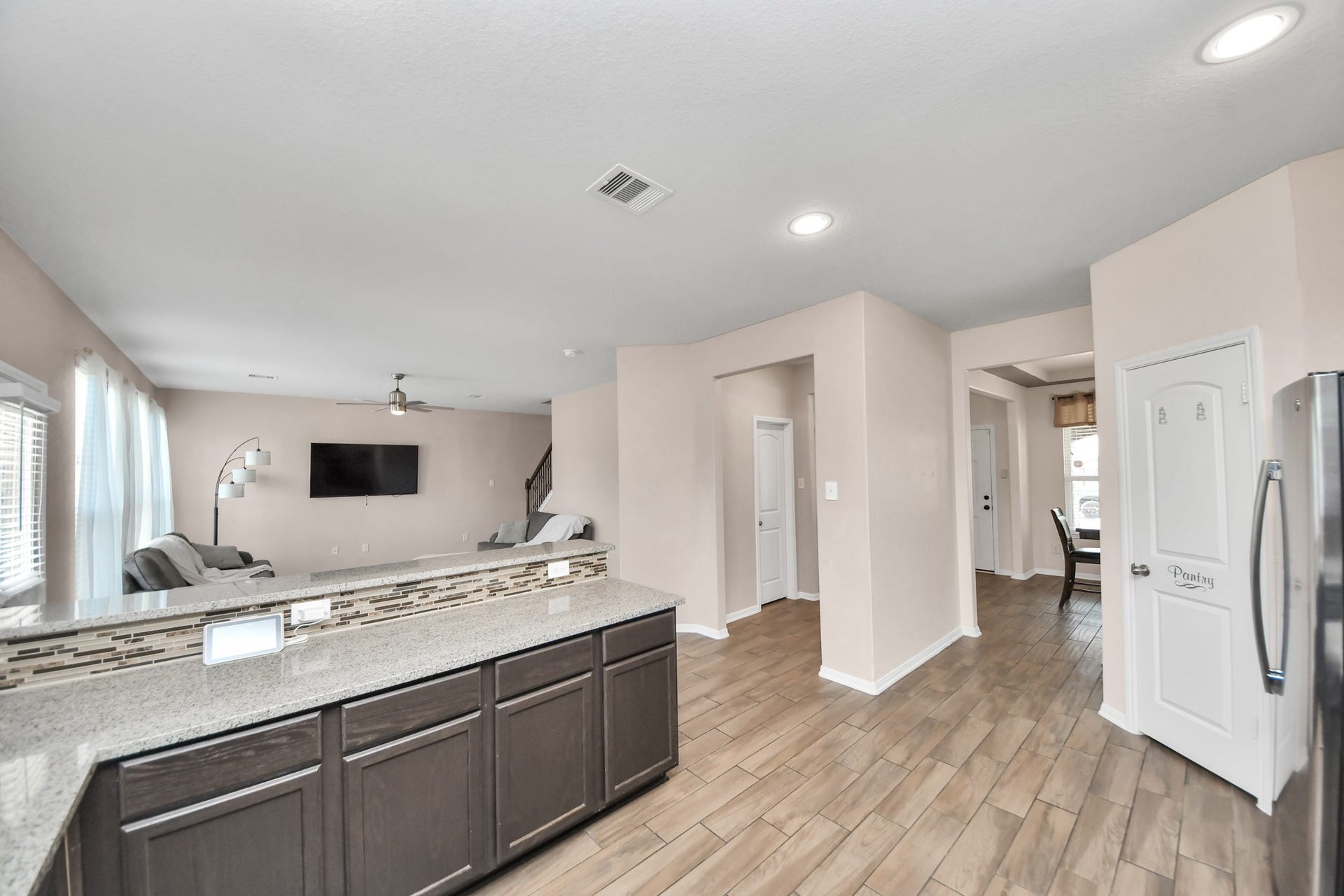 Extended counter space provides a convenient serving area for gatherings while maintaining clear views into the living room.