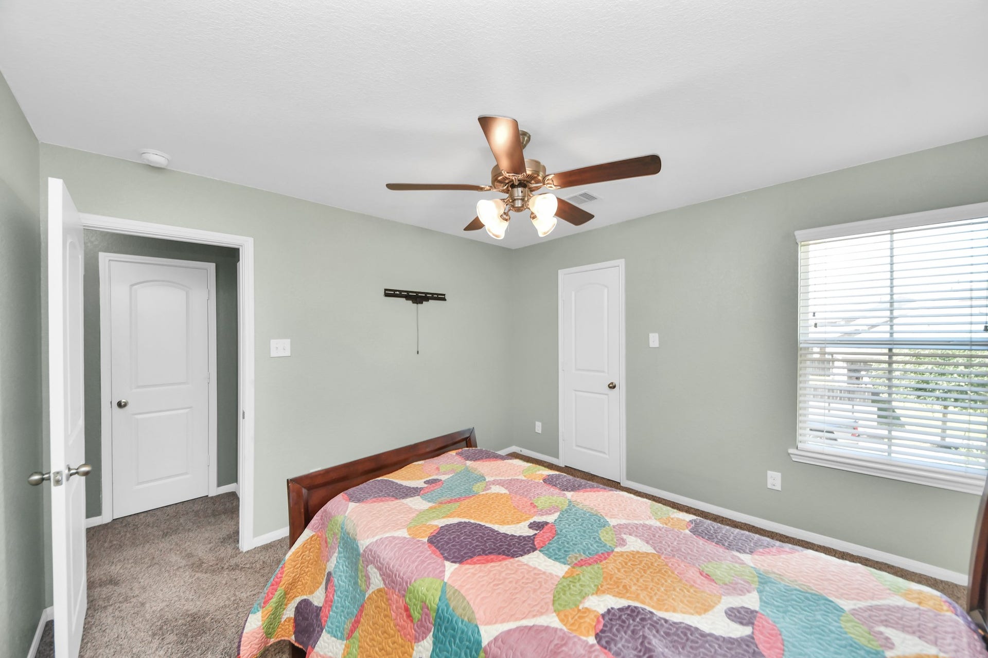 The secondary bedrooms flexible layout provides room for a sleeping area, study space and additional storage without feeling crowded.