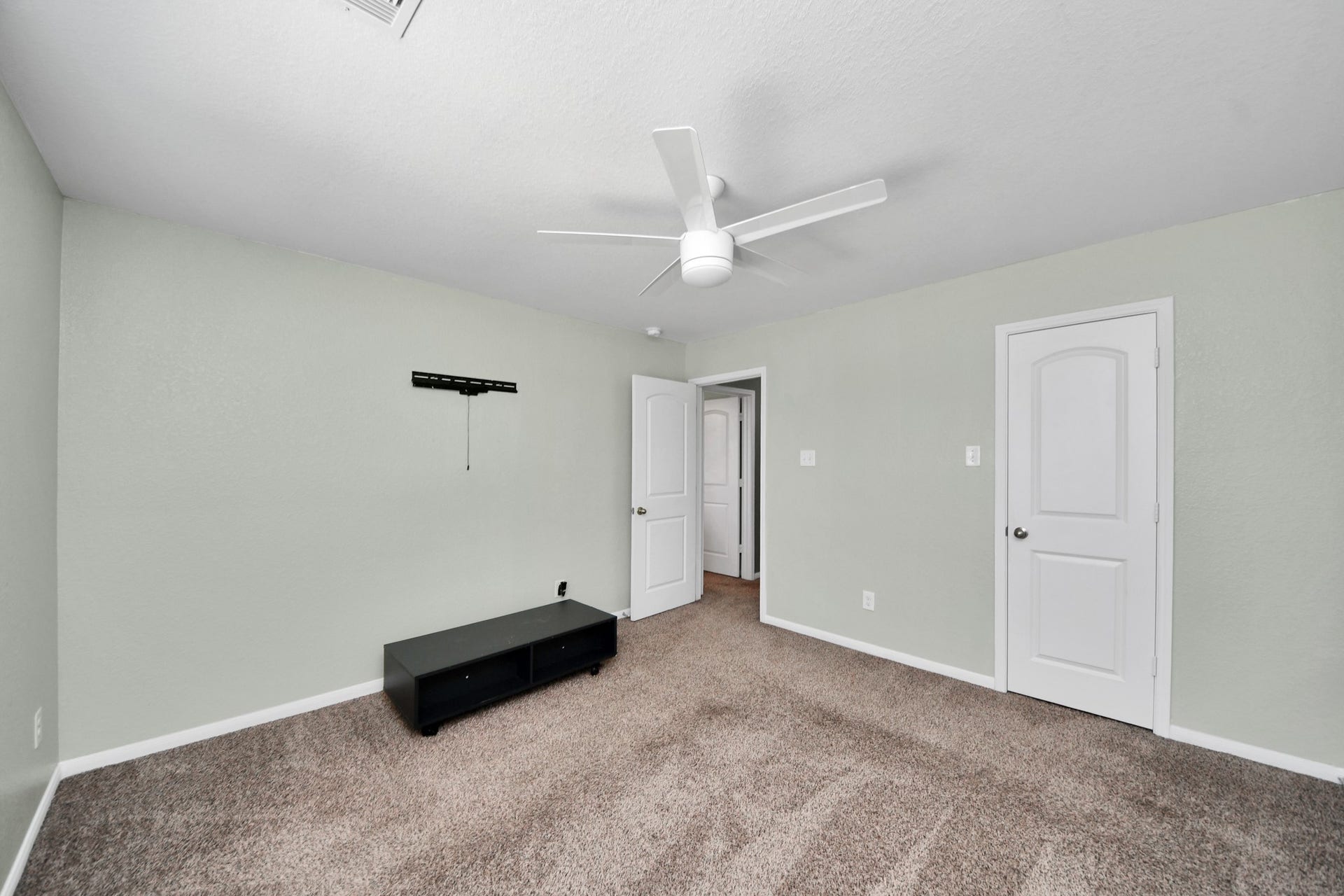 The third bedroom offers a roomy, versatile layout with a ceiling fan and convenient closet space.